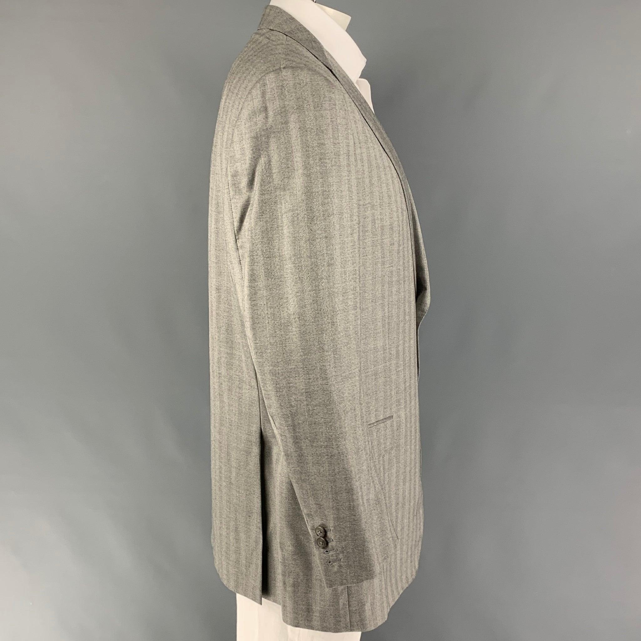 ERMENEGILDO ZEGNA
sport coat comes in a light gray herringbone cashmere / silk with a full liner featuring a notch lapel, flap pockets, double vent, and a double button closure. Very Good Pre-Owned Condition. 

Marked:   60 L  

Measurements: 
