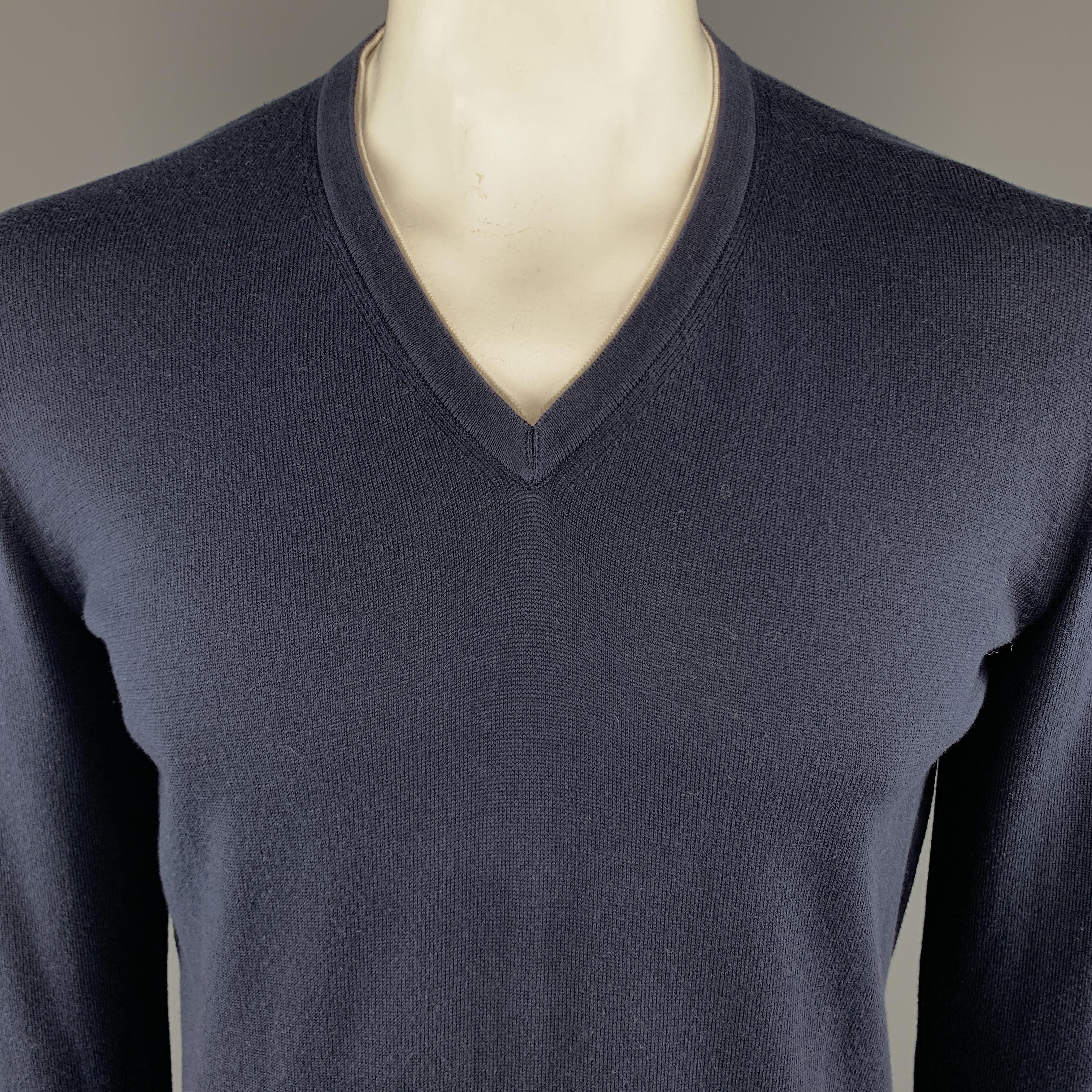 ERMENEGILDO ZEGNA Pullover Sweater comes in a navy tone in a solid cotton material, with a V-neck, a white trim, long sleeves and ribbed cuffs and hem. Made in Italy.
 
Excellent Pre-Owned Condition.
Marked: L
 
Measurements:
 
Shoulder: 18.5
