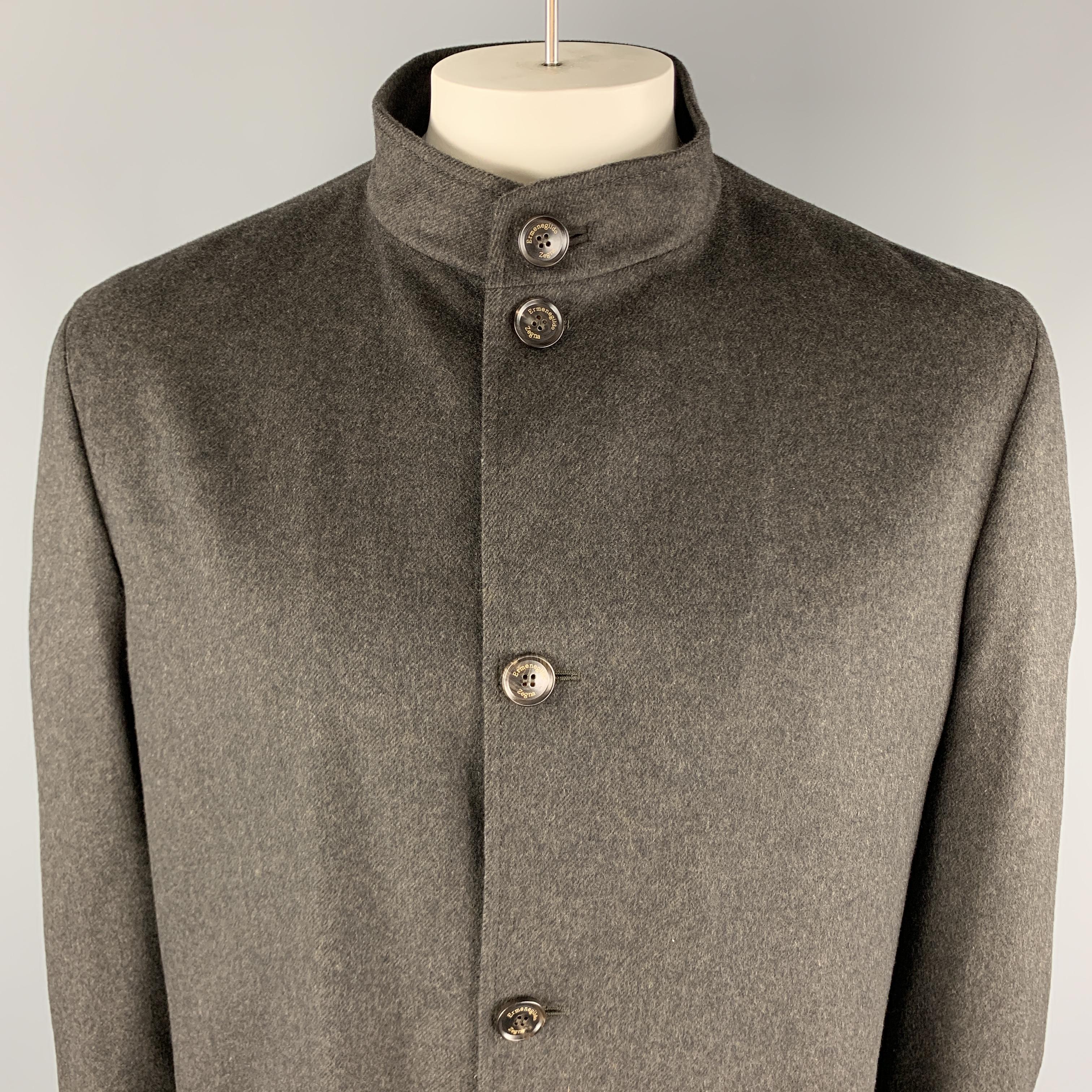ERMENEGILDO ZEGNA Jacket comes in a solid charcoal wool material, with a nehru collar, a buttoned front, patch pockets, unbuttoned cuffs and inner pockets. Made in Italy.

Excellent Pre-Owned Condition.
Marked: XXL / 56 

Measurements:

Shoulder: 19