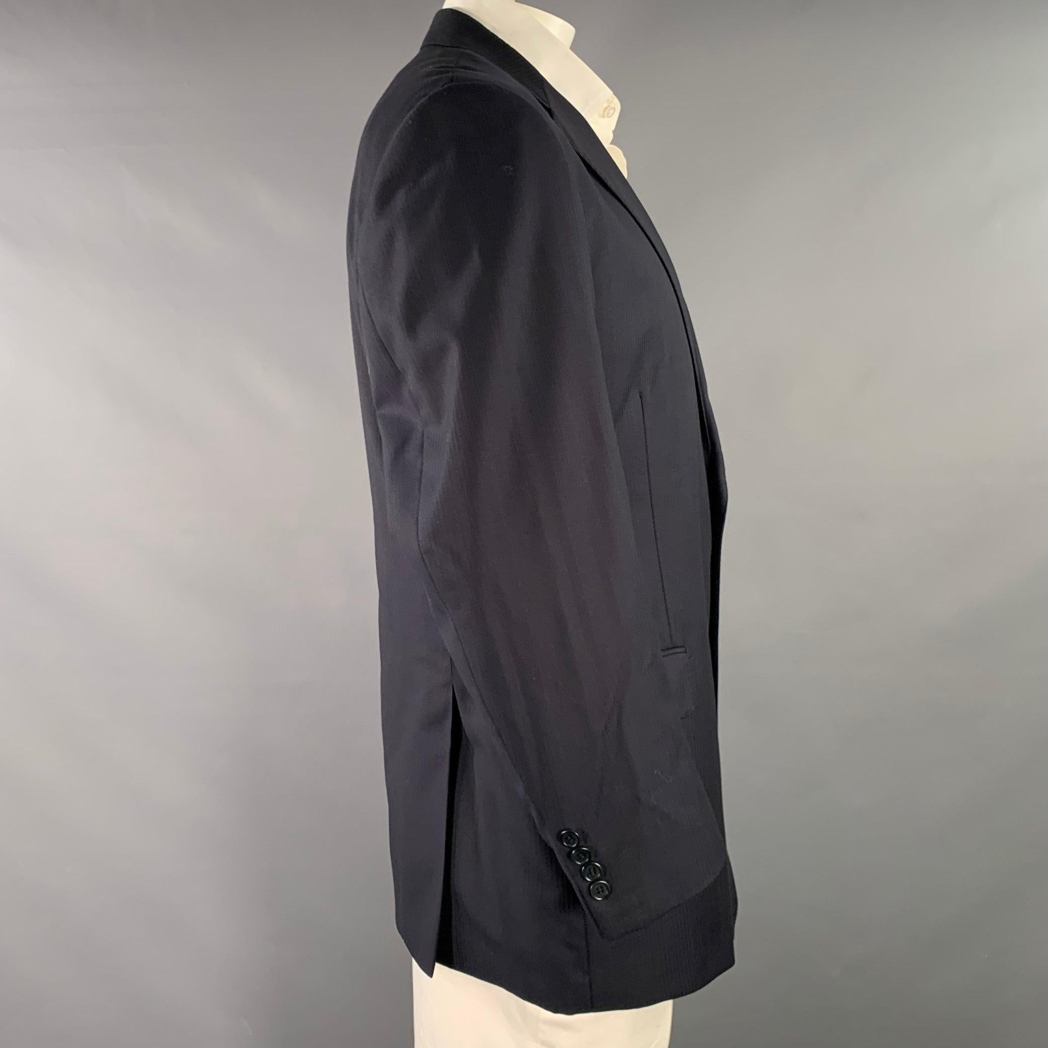 Vintage ERMENEGILDO ZEGNA sport coat
in a
navy wool silk fabric featuring a textured stripe pattern, notch lapel, double vented back, and double button closure. Made in Italy.Excellent Pre-Owned Condition. 

Marked:   46 

Measurements: 
 
Shoulder: