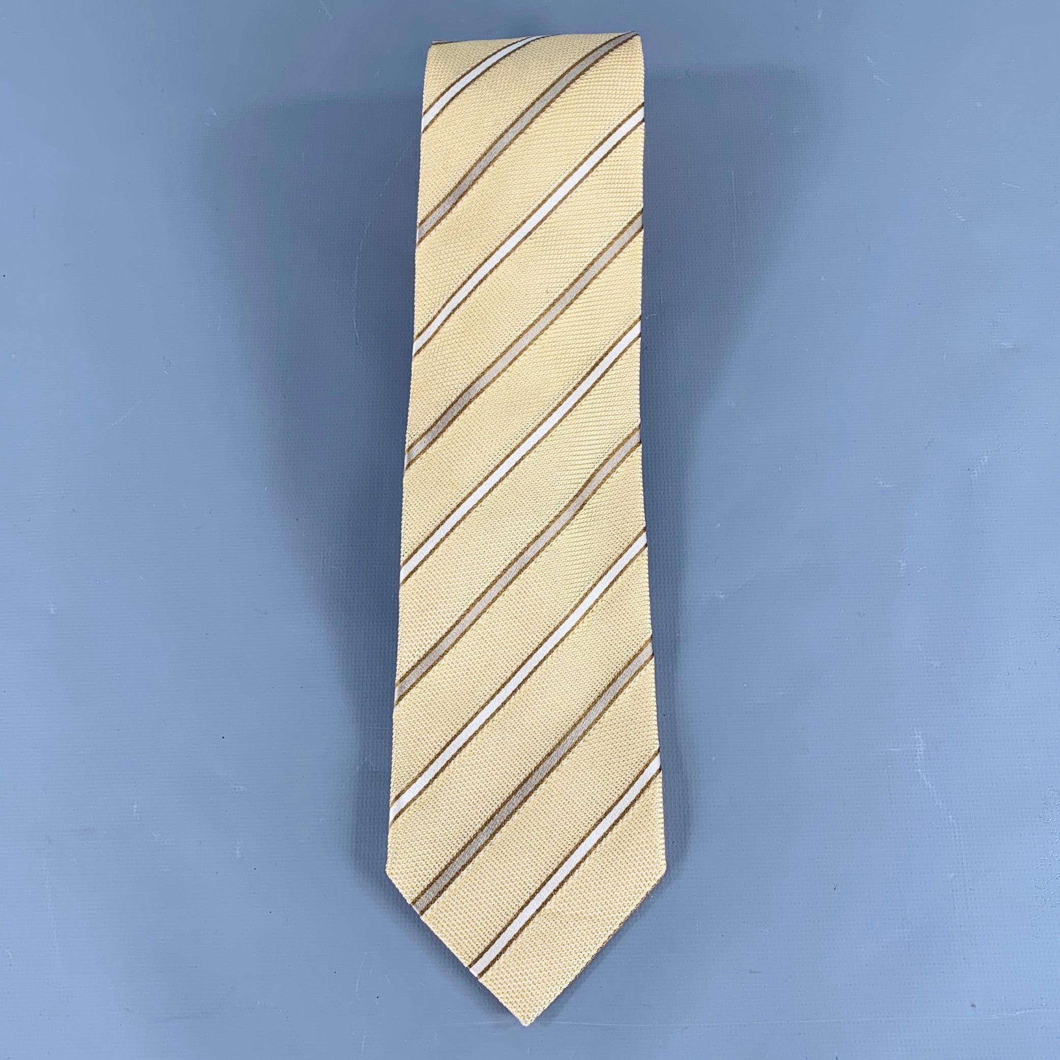 ERMENEGILDO ZEGNA necktie
in a yellow and taupe silk featuring a textured diagonal stripe pattern. Made in Italy.Very Good Pre-Owned Condition. Minor mark. 

Measurements: 
  Width: 3.25 inches Length: 60 inches 
  
  
 
Sui Generis Reference: