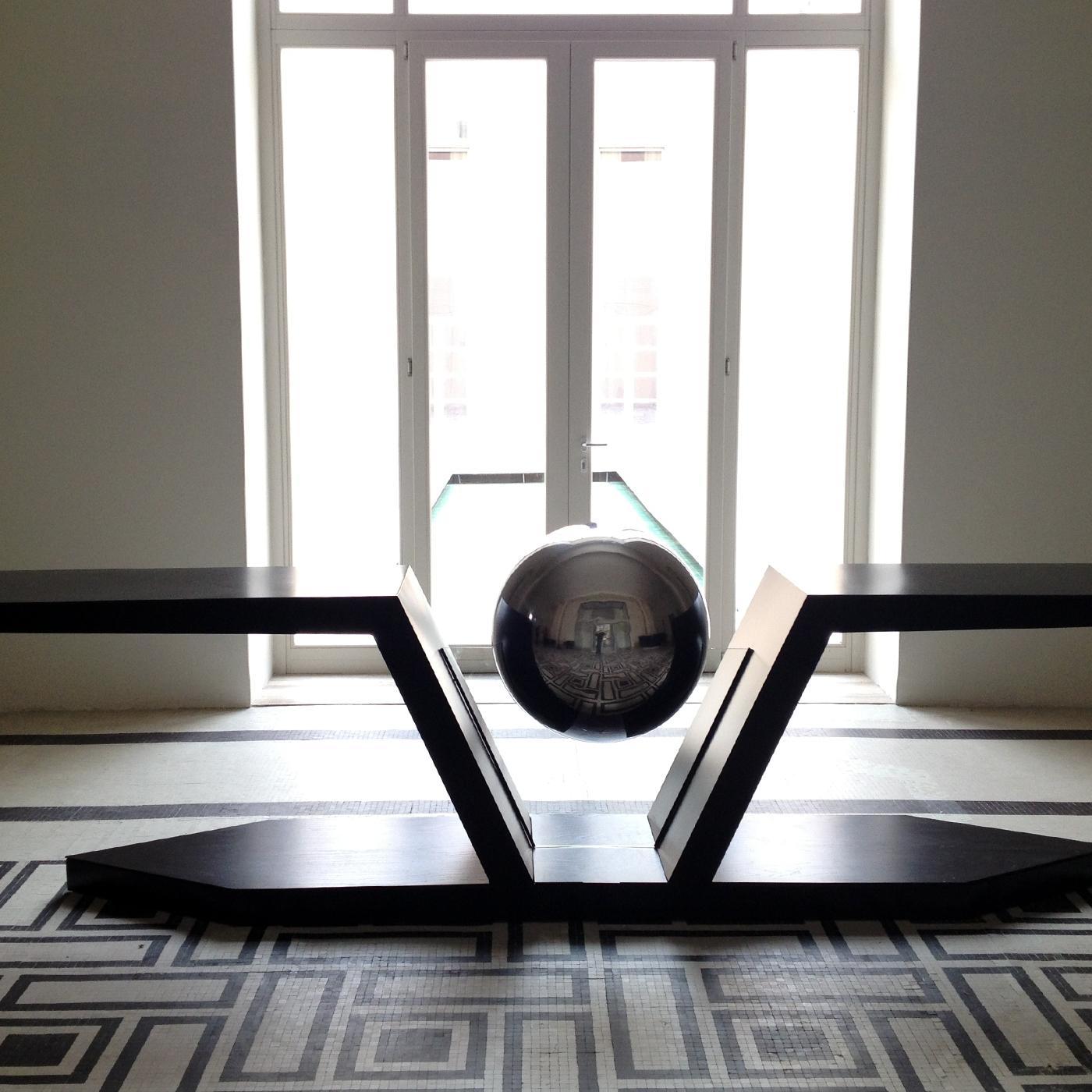 Inspired by Hermes - a herald and messenger of the Olympian gods in Greek mythology - this console astonishes with its winged design distinguished by a central steel sphere seemingly floating in mid-air. The sculptural structure incorporates glass