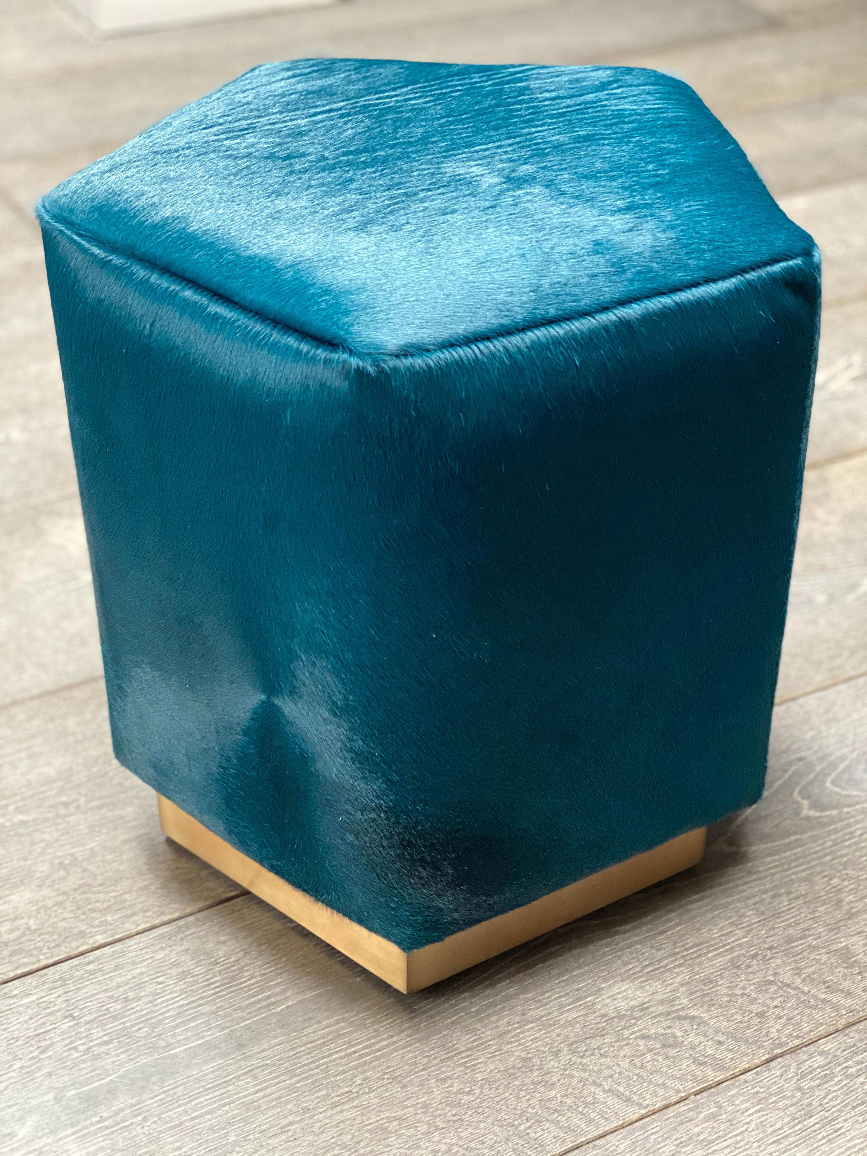 Introducing the Ermes Pouf from Casa Botelho - a funky and functional addition to any room! This pentagon-shaped pouf is a perfect balance of visual intrigue and versatility. Available in a range of colorful and textured fabrics, as well as metallic