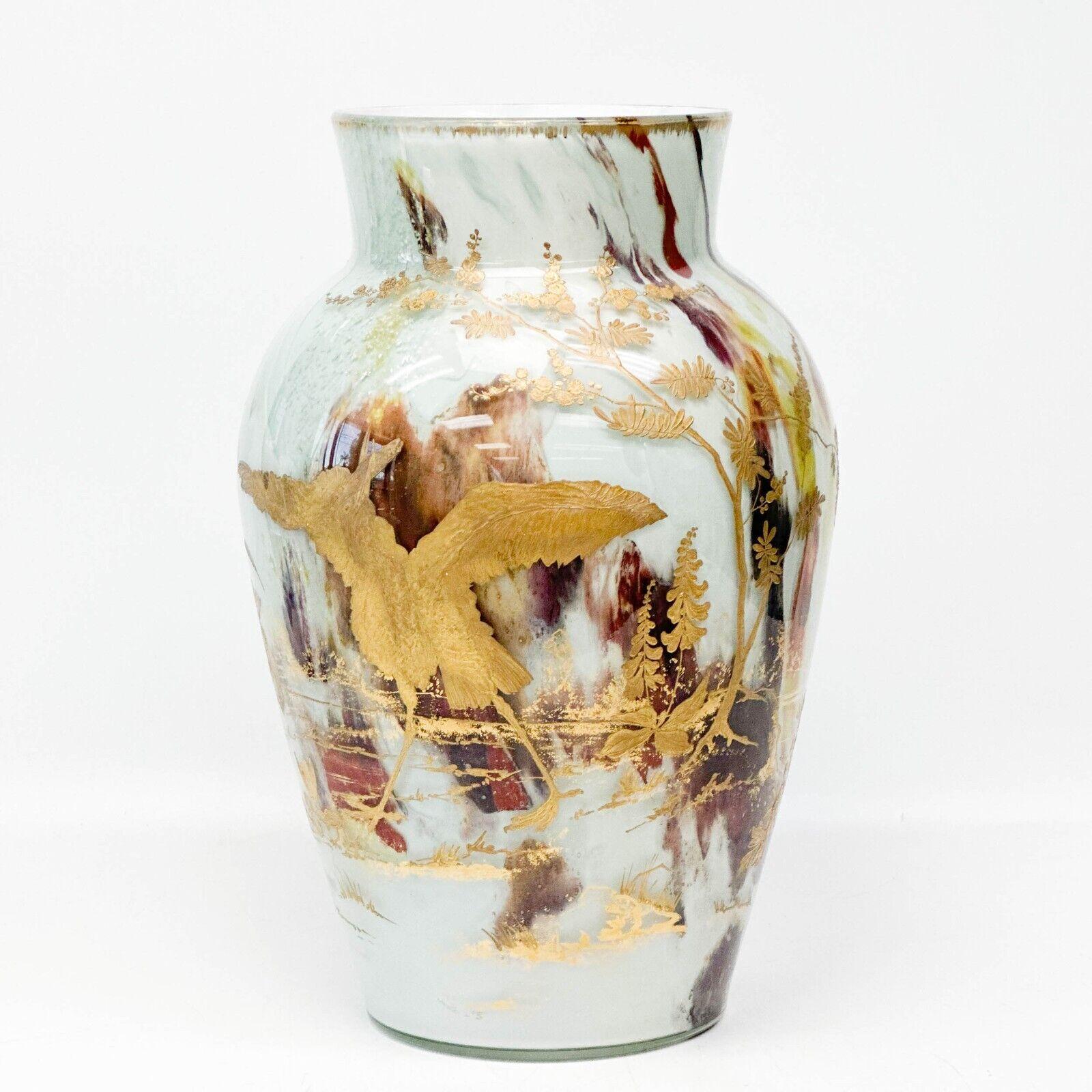  Ernest Baptiste Leveille Opaque Art Glass Vase, c1900 Gilt Florals

Opaque glass internally decorated with yellow, red, and blue, silver metal flakes. Raised gilt floral decoration to the exterior of  thistles, irises, and a crane, gilt to the rim.
