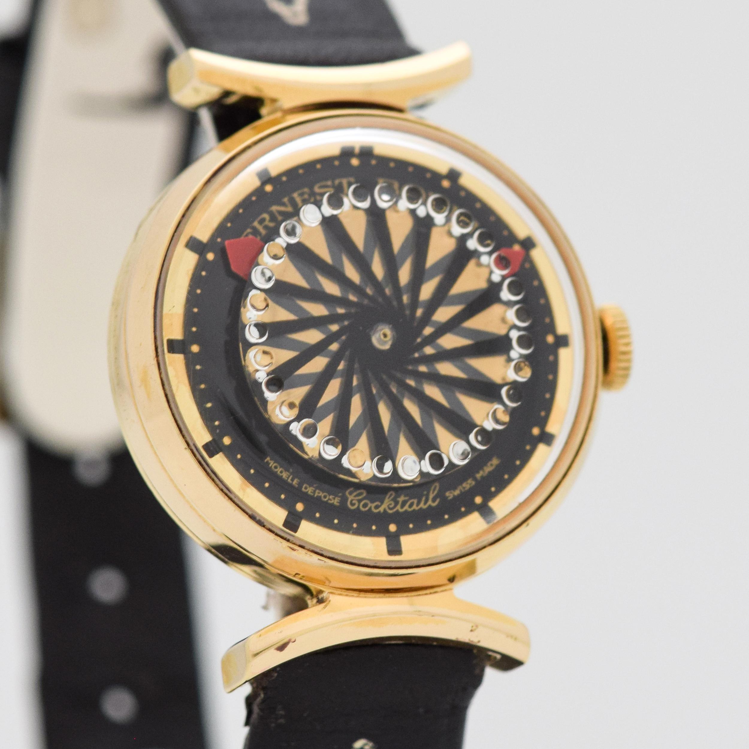 1990's Ernest Borel Ladies Synchron 26 Cocktail Yellow Gold Plated watch with Original Kaleidoscope Black and Gold Dial with Exhibition Case Back with Original Ernest Borel Black Leather Strap and Gold Plated Buckle. Case size, 25mm wide. Powered by