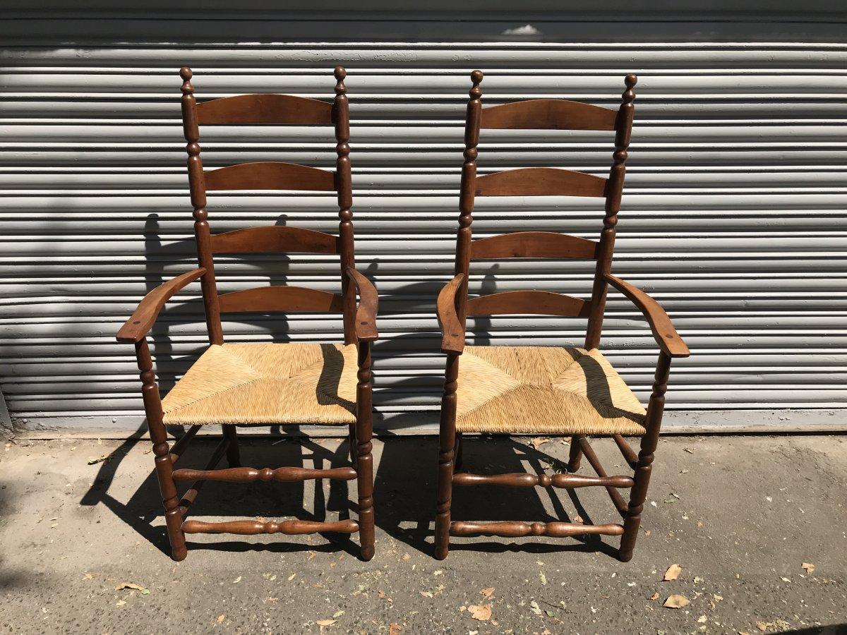 Ernest Gimson, designer. A good quality pair of Cotswold School yew wood ladder back and bobbin-turned armchairs with rush seats.