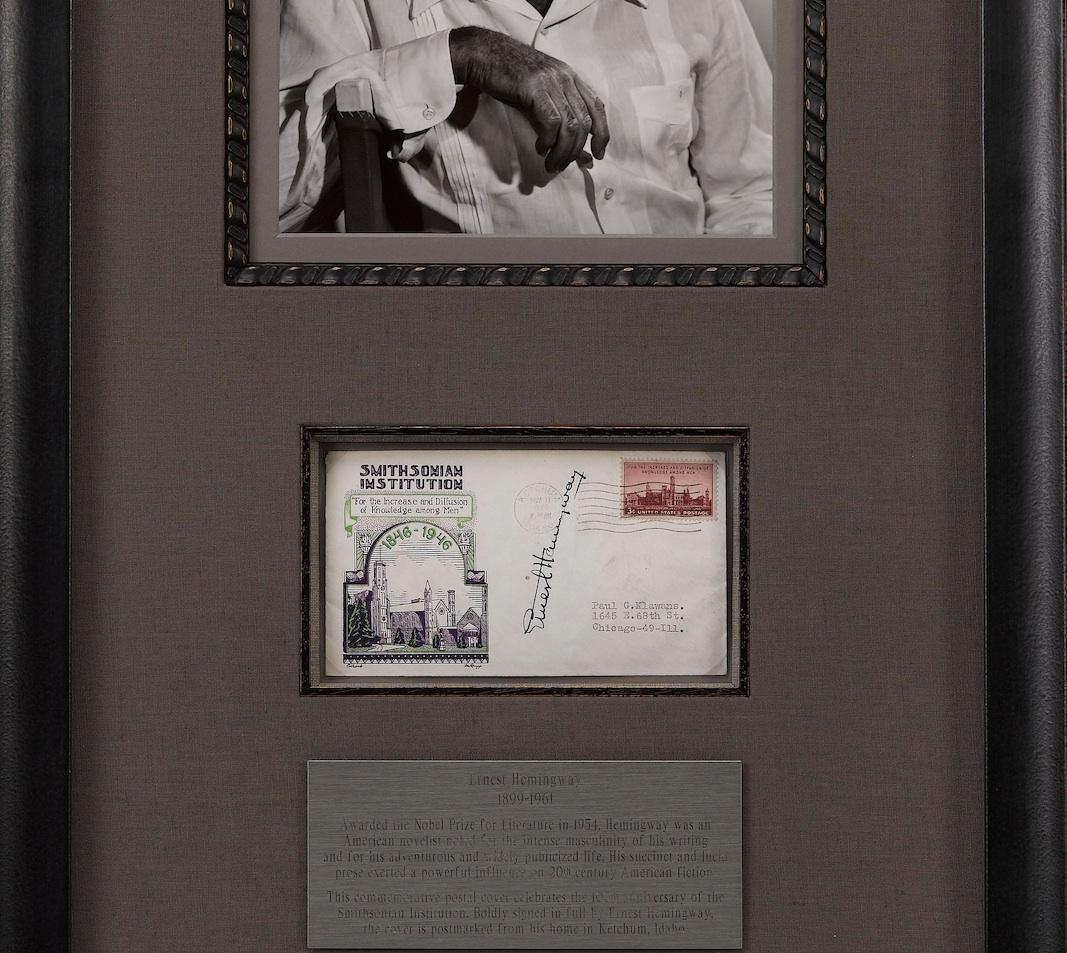 Offered is a unique Ernest Hemingway collage featuring his signature on a post card. The post card includes a printed depiction of the Smithsonian Institution at left and a 3 cent stamp at top right. Hemingway has signed the card on the vertical