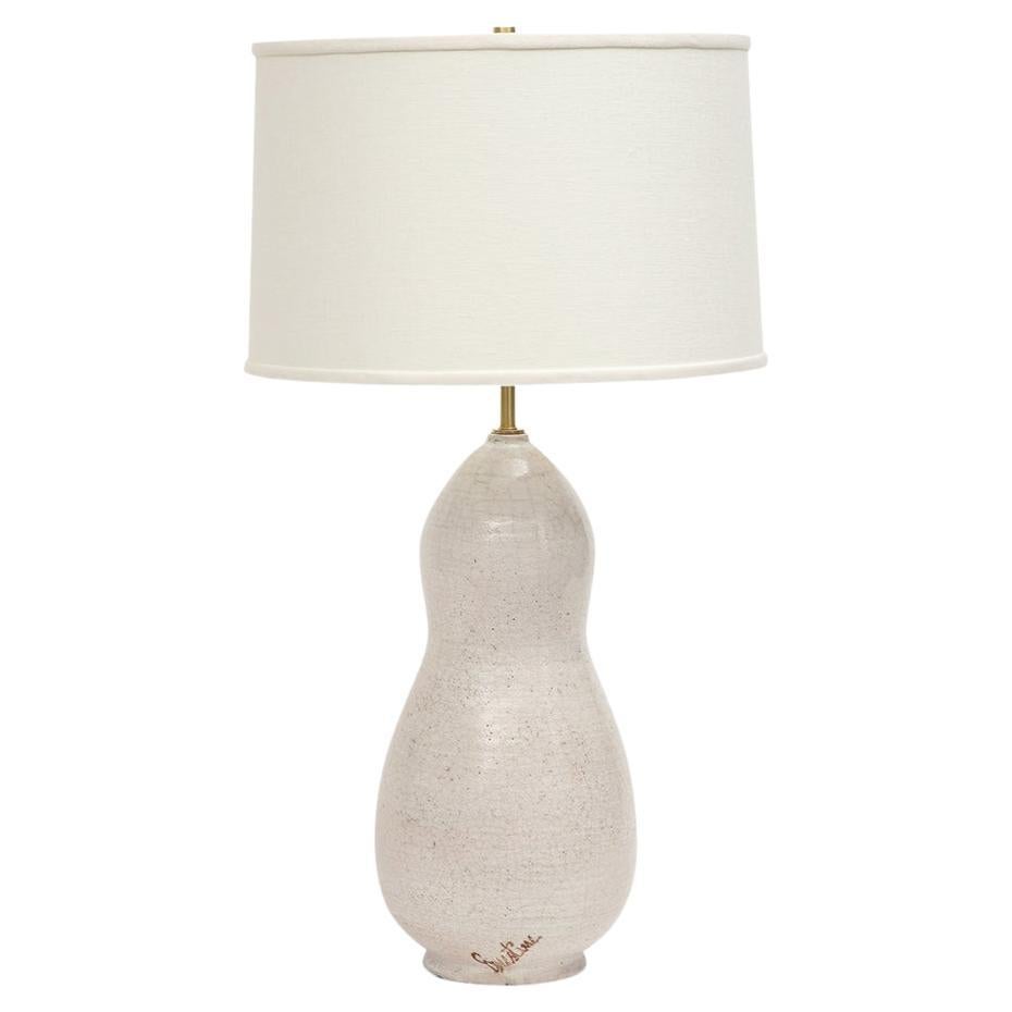 Ernestine Table Lamp, Ceramic, White, Signed. Large, gracefully proportioned double gourd form lamp with footed base and glazed in off-white. The ceramic body measures 17.25 inches high by 8.5 inches across its widest point. Glazed signature on body