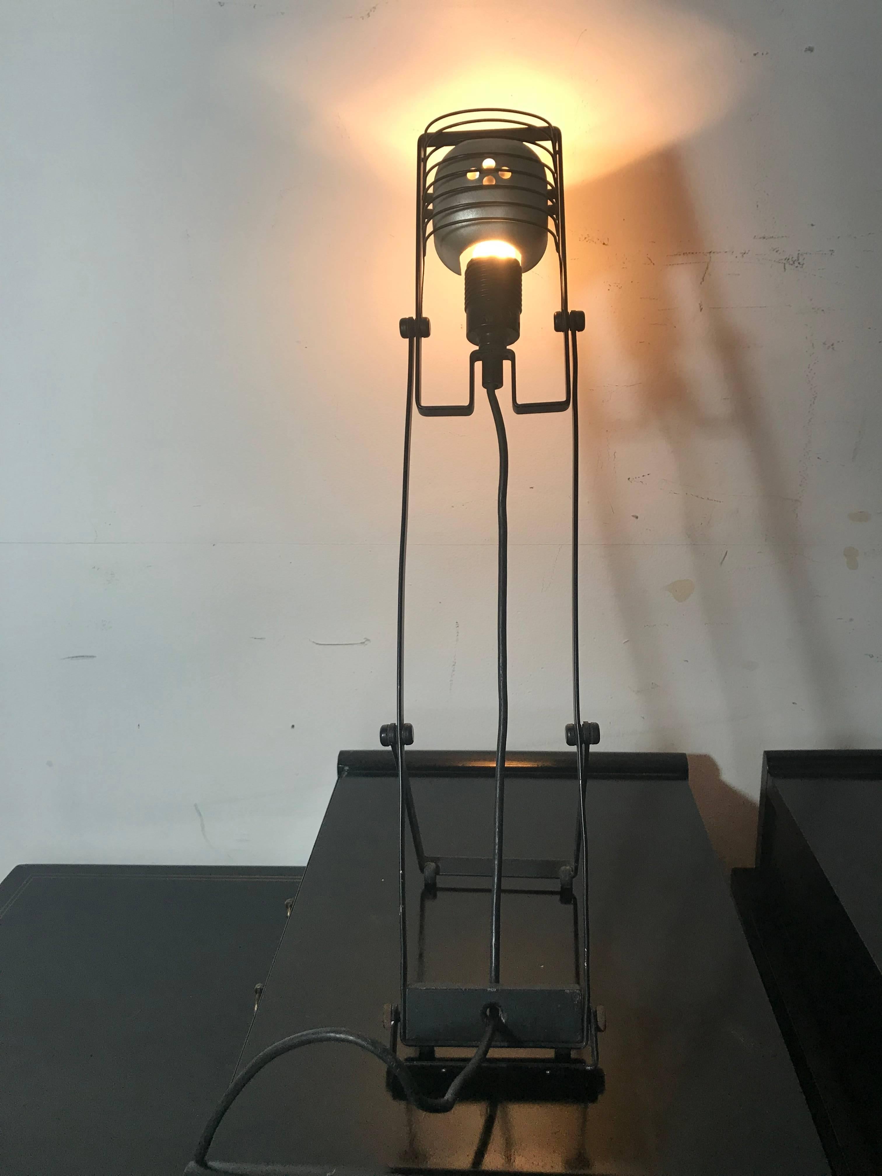 The Sintesi lamp was designed in 1976 by Ernesto Gismondi, the founder of the Italian lighting company Artemide. It is made of aluminium, rubber and plastic.

The Sintesi is part of the permanent collection of the Metropolitan Museum of Art in New