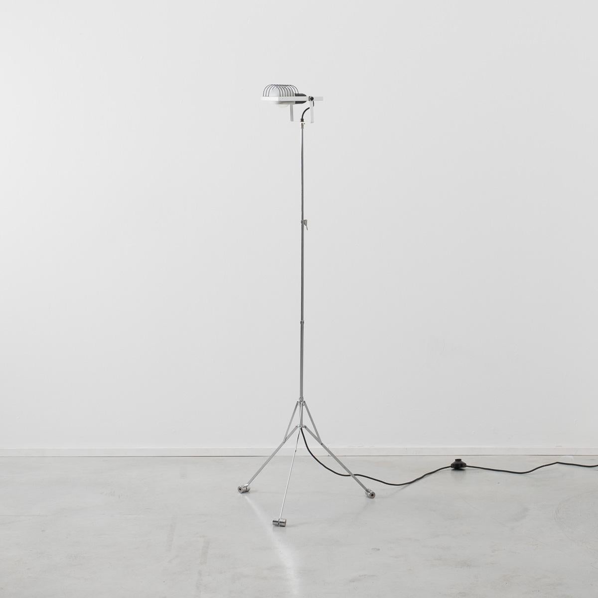 A rare floor standing lamp from the Sintesi range that uses the form of a music Stand turns it into a lamp. In Classic Postmodern style two items that ordinarily would have little in common are designed into each other with tongue firmly in cheek.