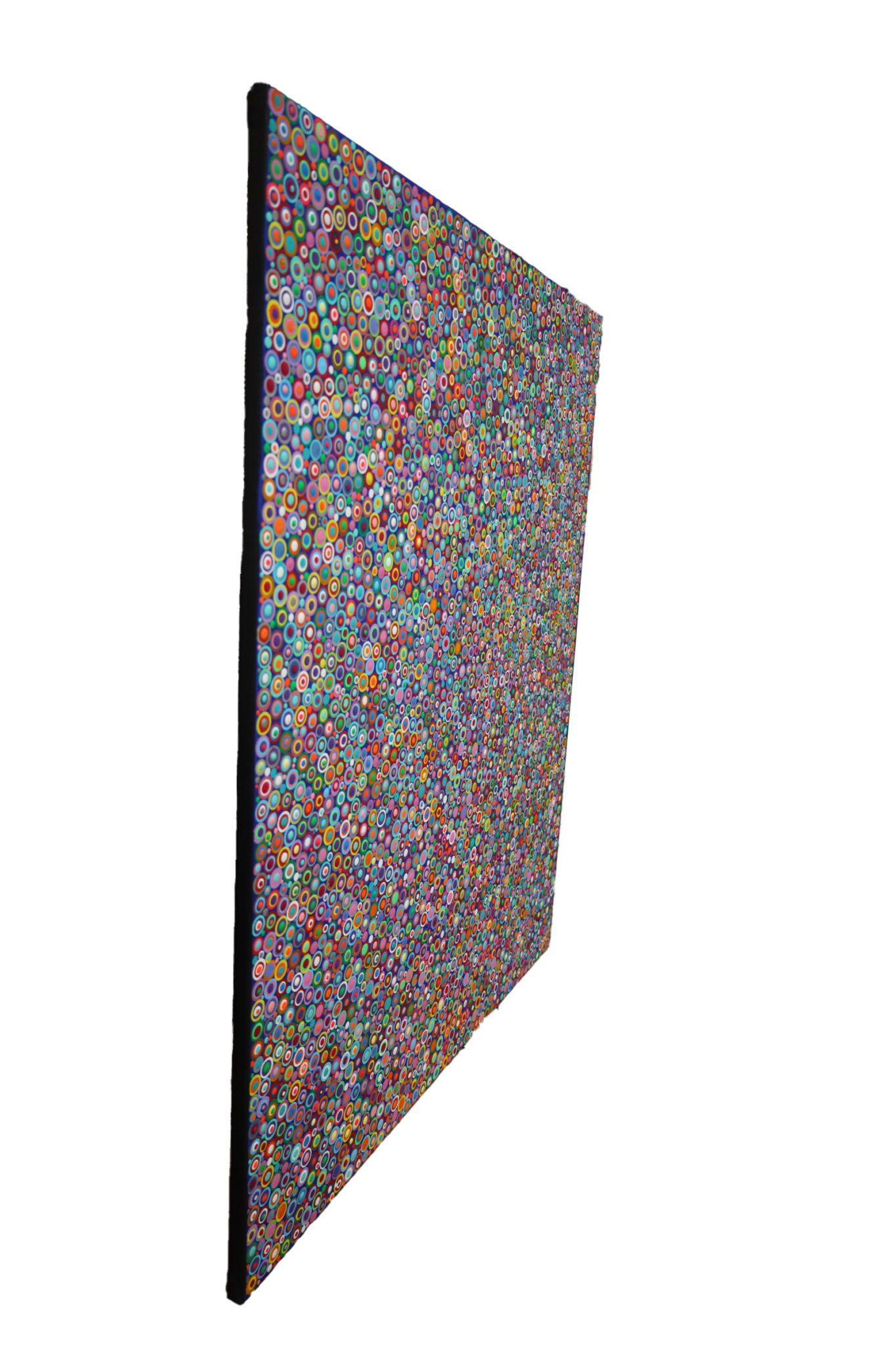 In the artwork “10101 Dots” the viewer encounters a vibrant display of myriad small circles, each filled with different colors and patterns. The circles are densely packed across the canvas, creating an effervescent mosaic of hues that range from