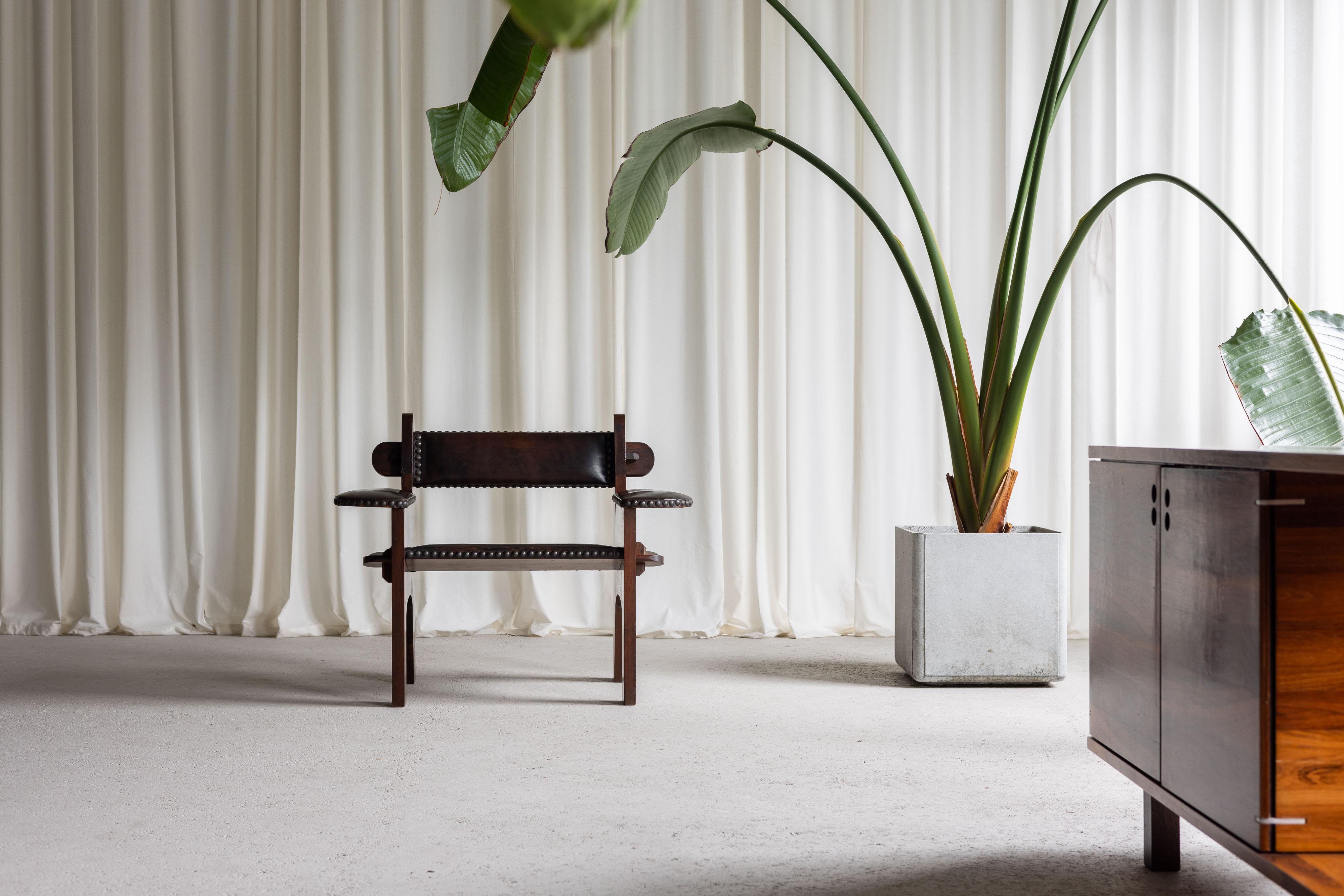 The brutalist armchair designed by Ernesto Valabrega in the 1950s is a striking piece of mid-century Italian craftsmanship. Constructed from solid cedar wood, this chair epitomizes the rugged elegance characteristic of brutalist design. The