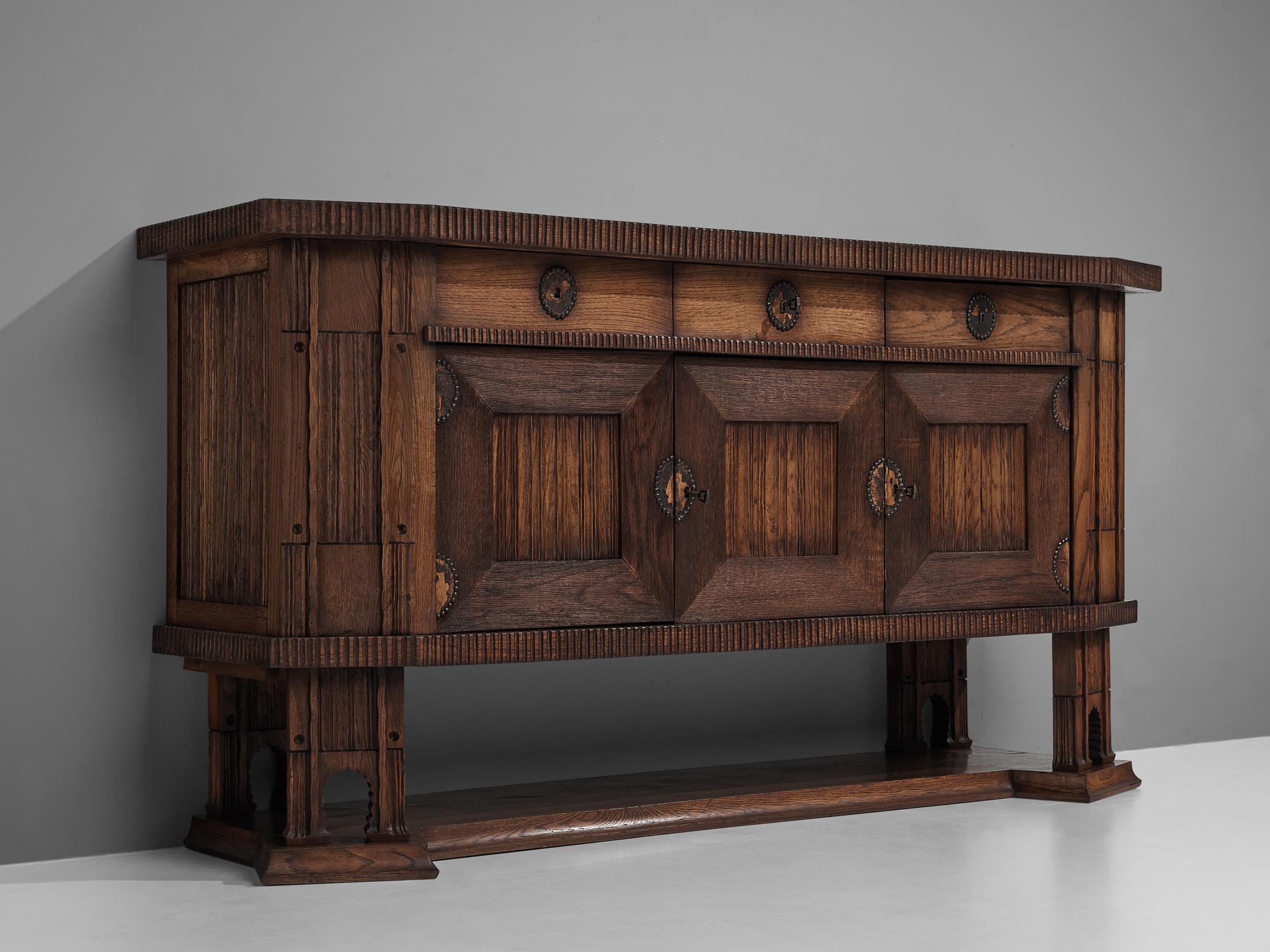Ernesto Valabrega, sideboard, oak, Italy, 1930s

This large sideboard in oak by Ernesto Valabrega features not only visual qualities but also great storage space. Three drawers and three doors are structuring the outside and are furnished with