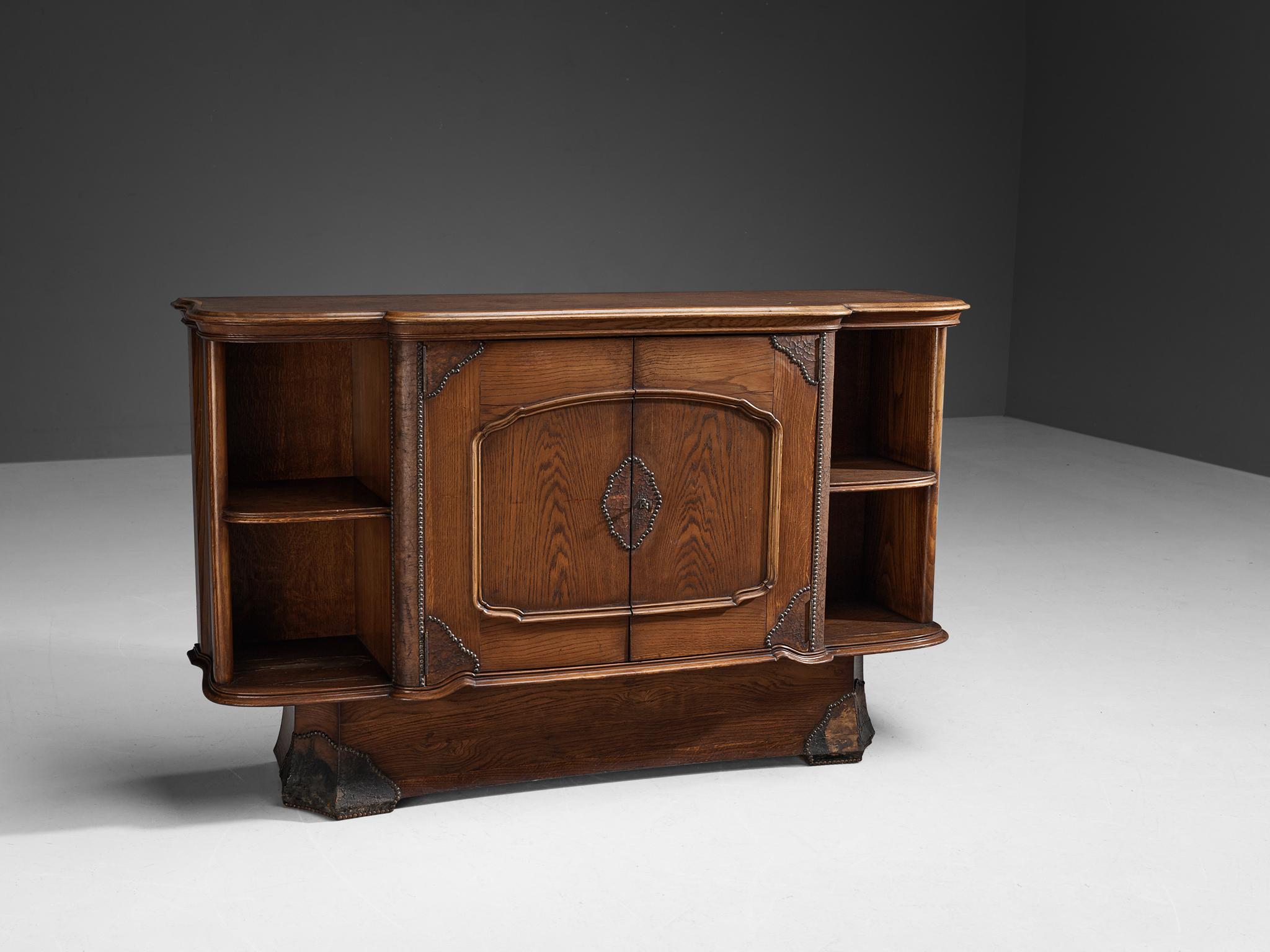 Ernesto Valabrega, cabinet, oak, leather, metal, Italy, circa 1935

This large cabinet in oak by Ernesto Valabrega features not only visual qualities but also great storage space. Two doors are structuring the outside and are furnished with a lock.
