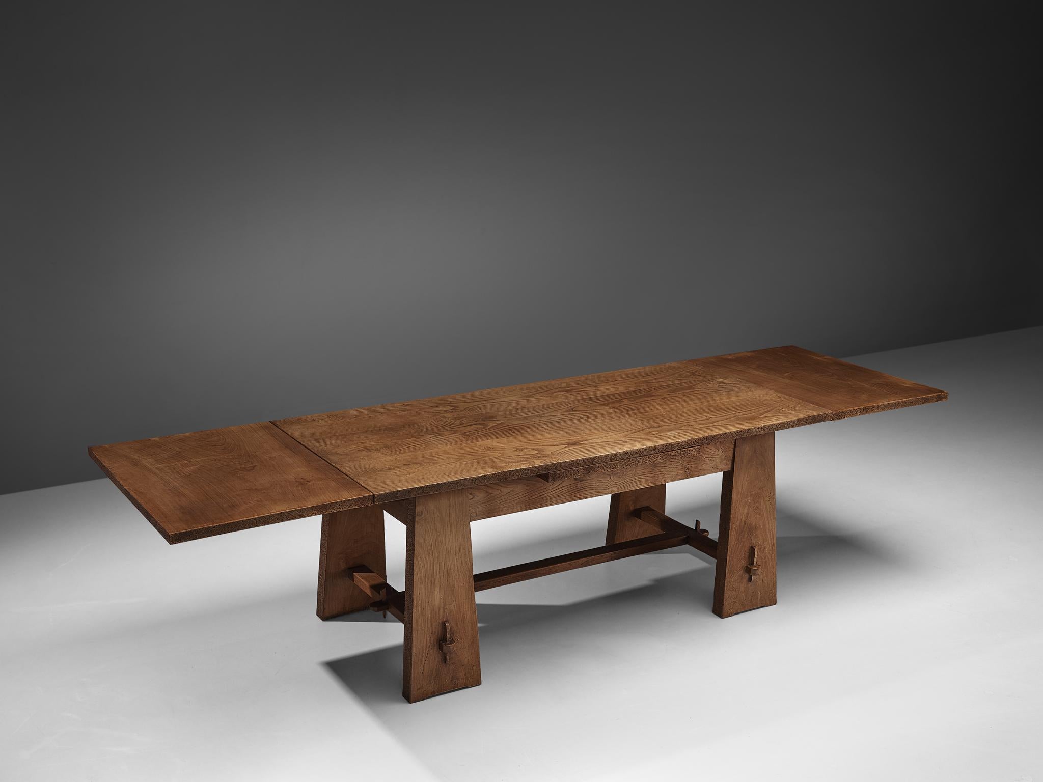 Ernesto Valabrega, dining table, oak veneer, wood, Italy, ca. 1935

This extendable dining table features two leaves that are 'hidden' under the tabletop. The leaves can be used to extend the table on one or both sides. Four flat legs are tapered