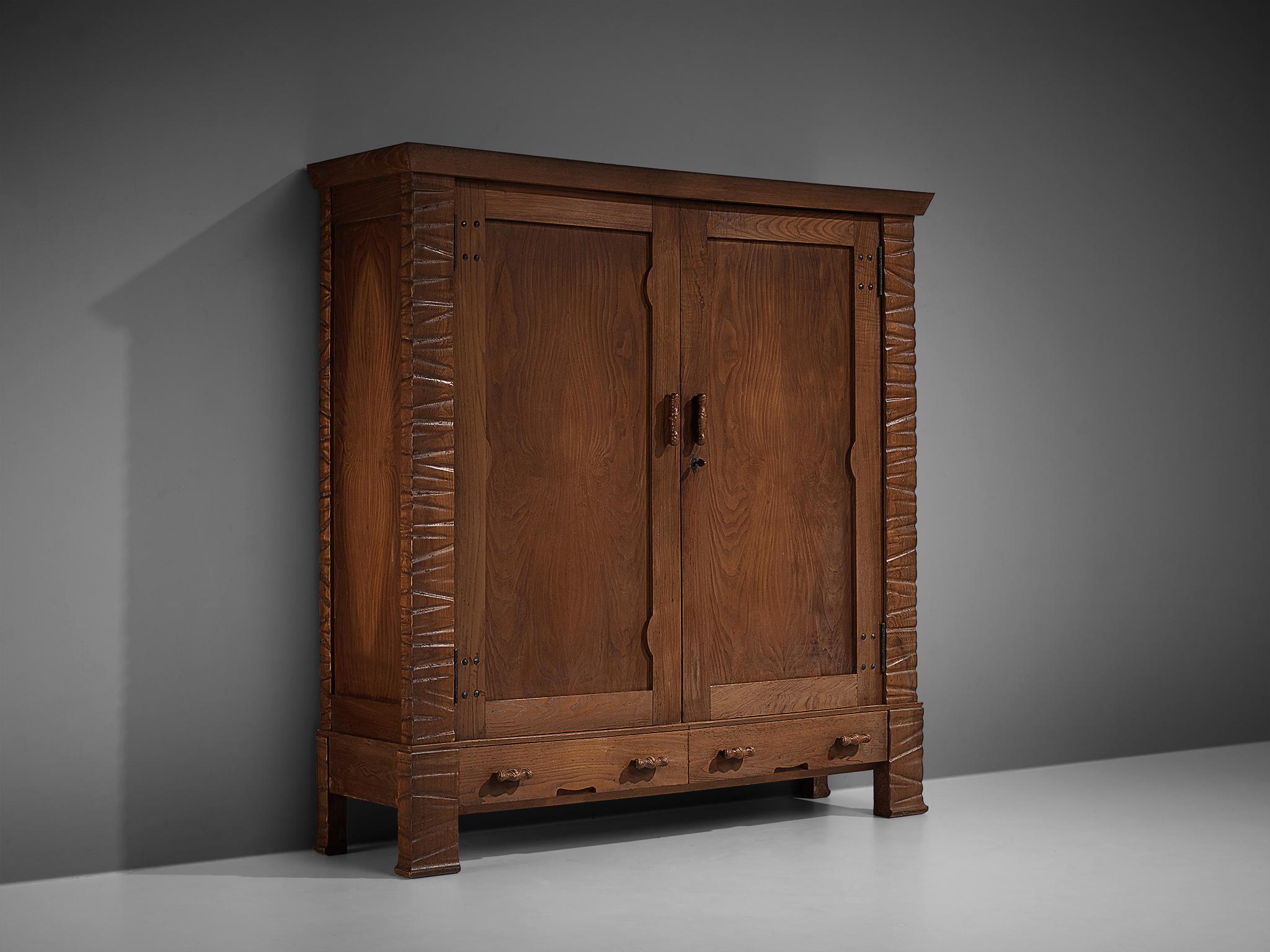 Ernesto Valabrega, wardrobe, oak, glass, Italy, ca. 1935

This large wardrobe shows the characteristics of Ernesto Valabrega's designs. The dynamic engraved corners in combination with long, rounded handles. With drawers at the bottom and two doors