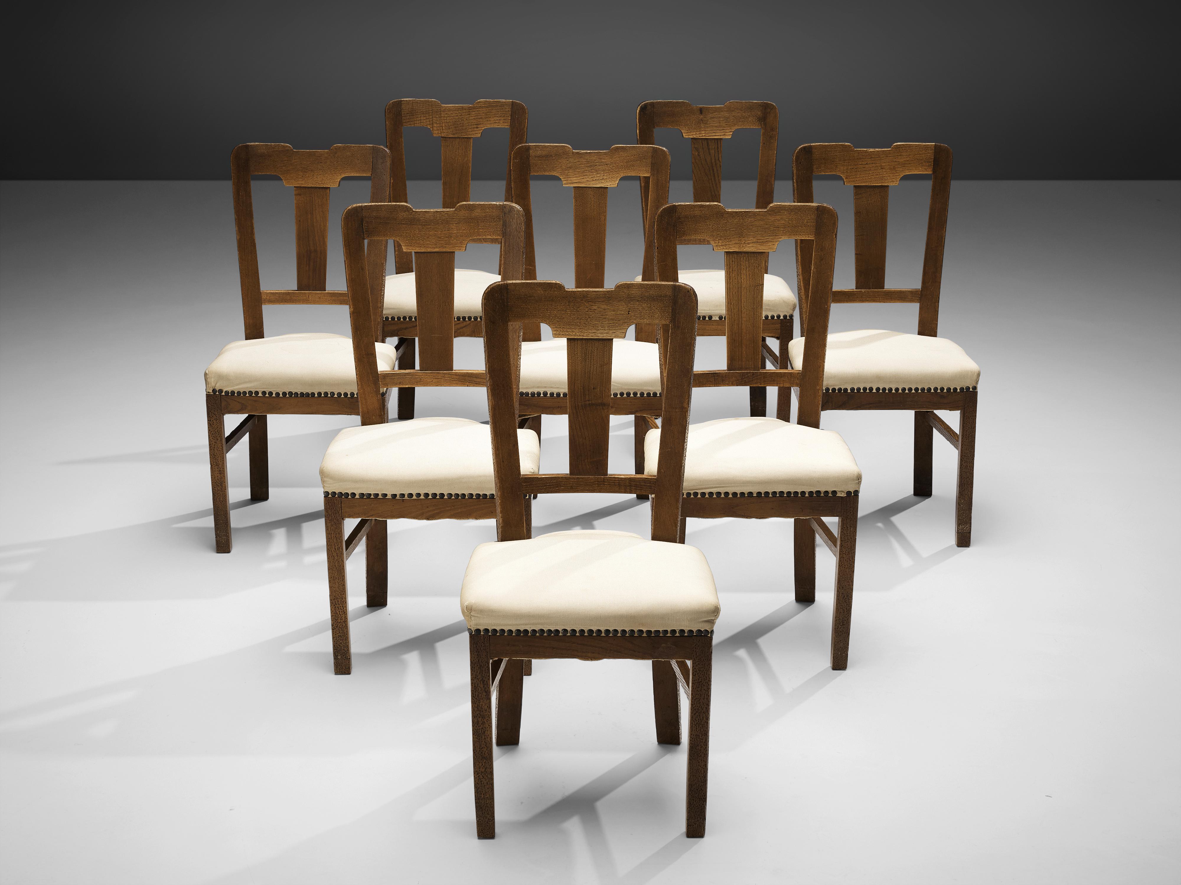Ernesto Valabrega, set of eight dining chairs, stained oak, fabric upholstery, Italy, ca. 1935

This set of dining chairs by Ernesto Valabrega not only shows a well-balanced backrest but also lovely details like the brass nails holding the seating