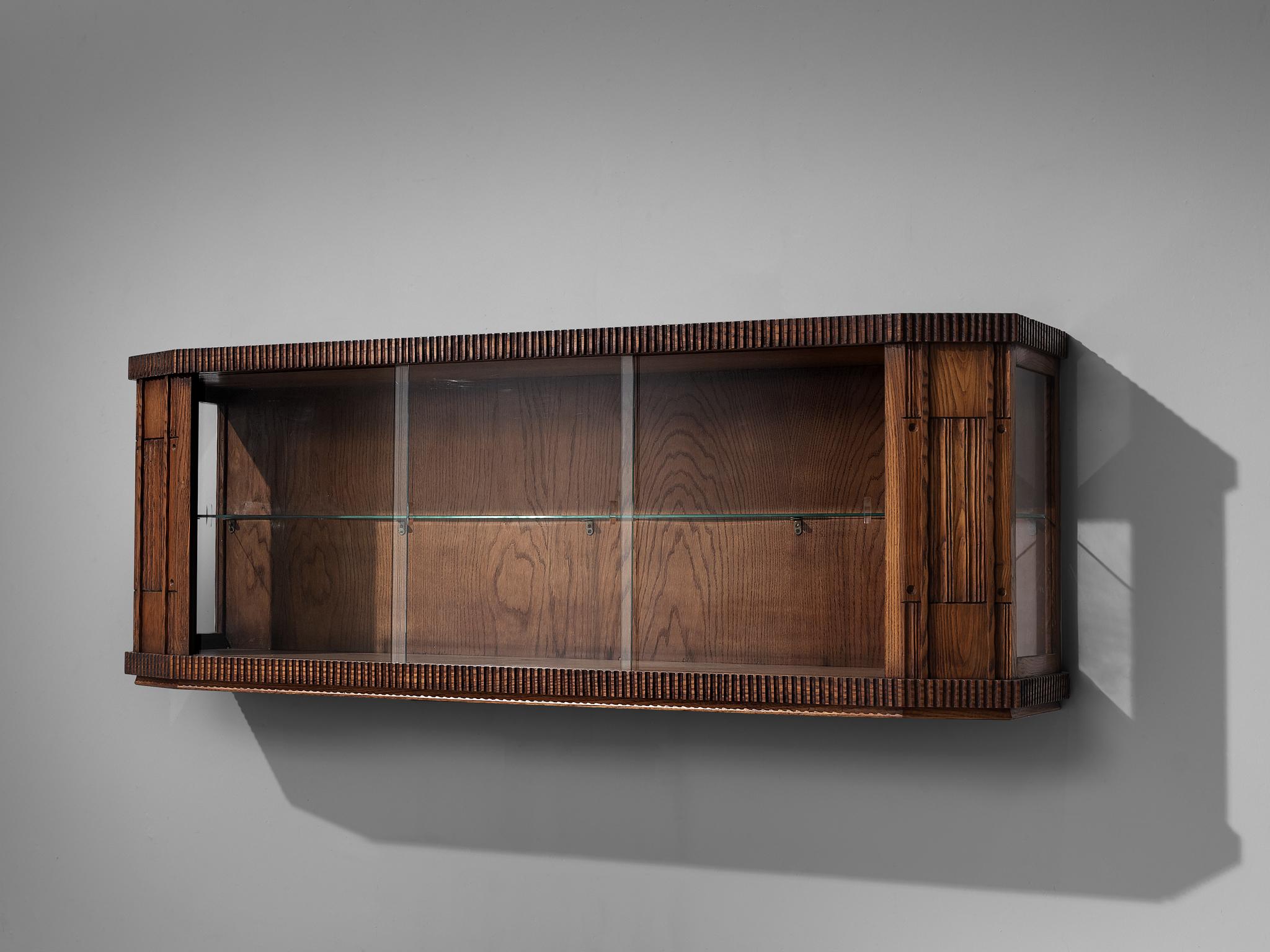 Ernesto Valabrega, showcase, oak, glass, Italy, 1930s. 

This Art Deco showcase is designed by Ernesto Valabrega and can be placed on top of a sideboard or adjusted to a wall. Three glass sliding doors at the front provide access to the inner