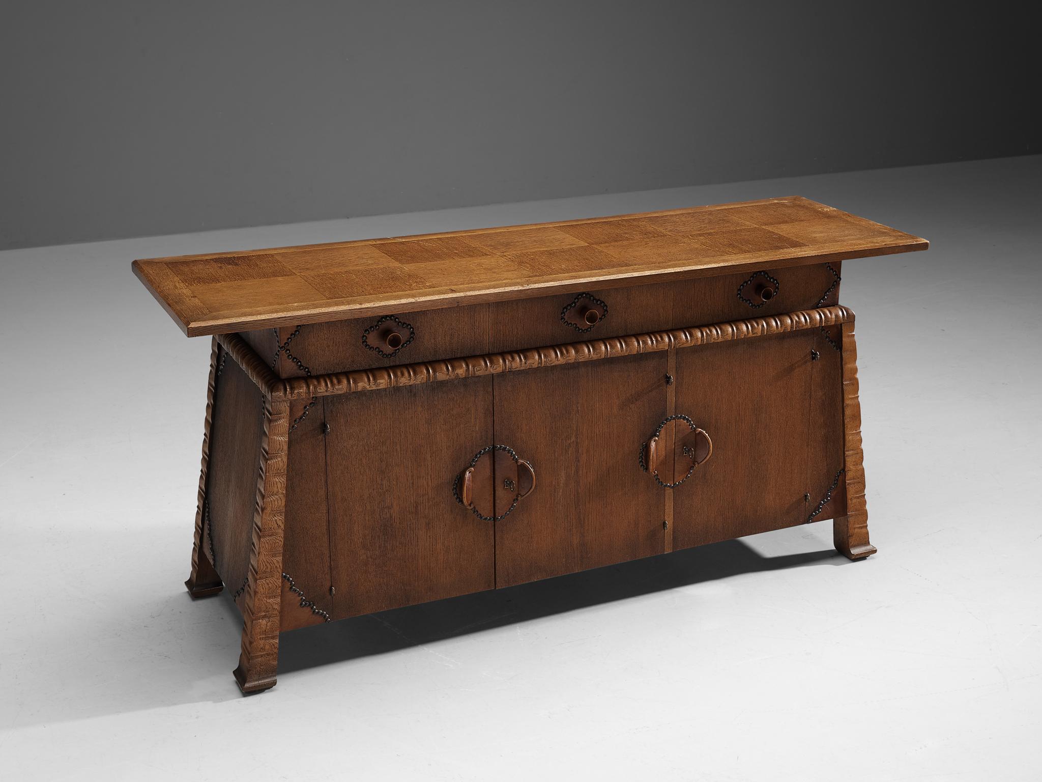 Ernesto Valabrega, cabinet, oak, metal, Italy, ca. 1935.

This stunning cabinet shows the characteristics of Ernesto Valabrega's designs. Note for example the checkered inlay of the oak wooden top. The dynamic engraved corners that continue