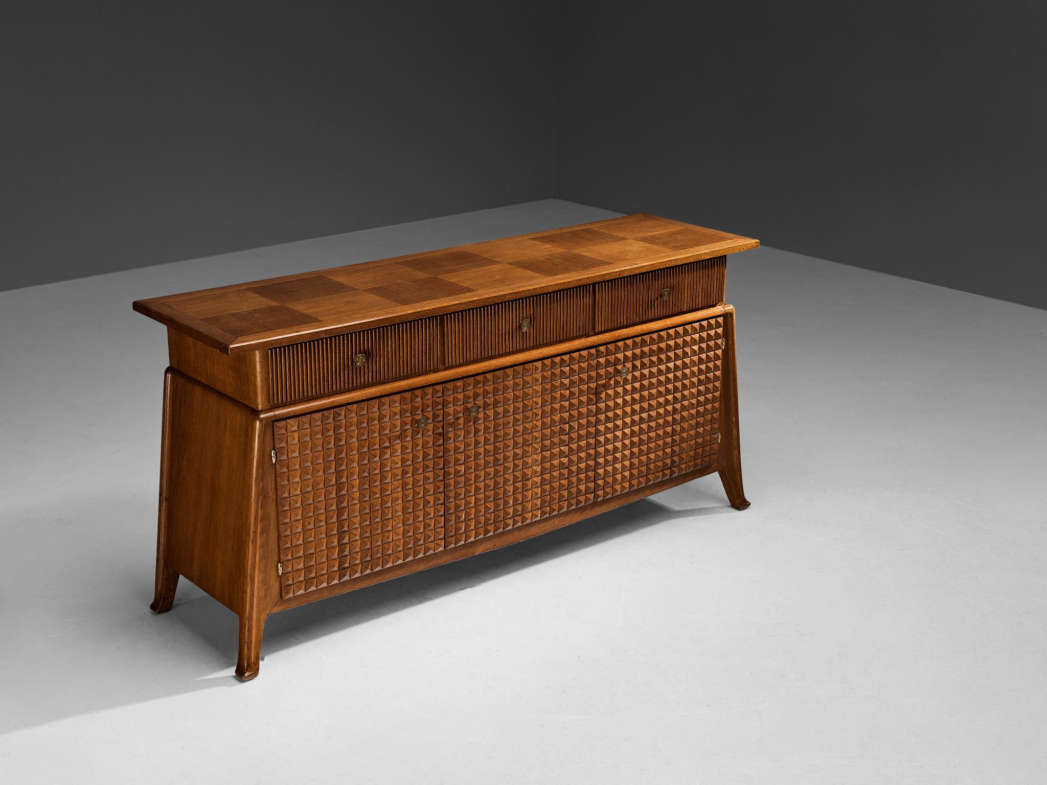 Ernesto Valabrega, sideboard, stained oak, brass, Italy, circa 1935 

This sideboard by Italian designer Ernesto Valabrega is exemplary for refined, highly detailed and very well-made furniture. The lower part of the corpus is based on a trapezoid