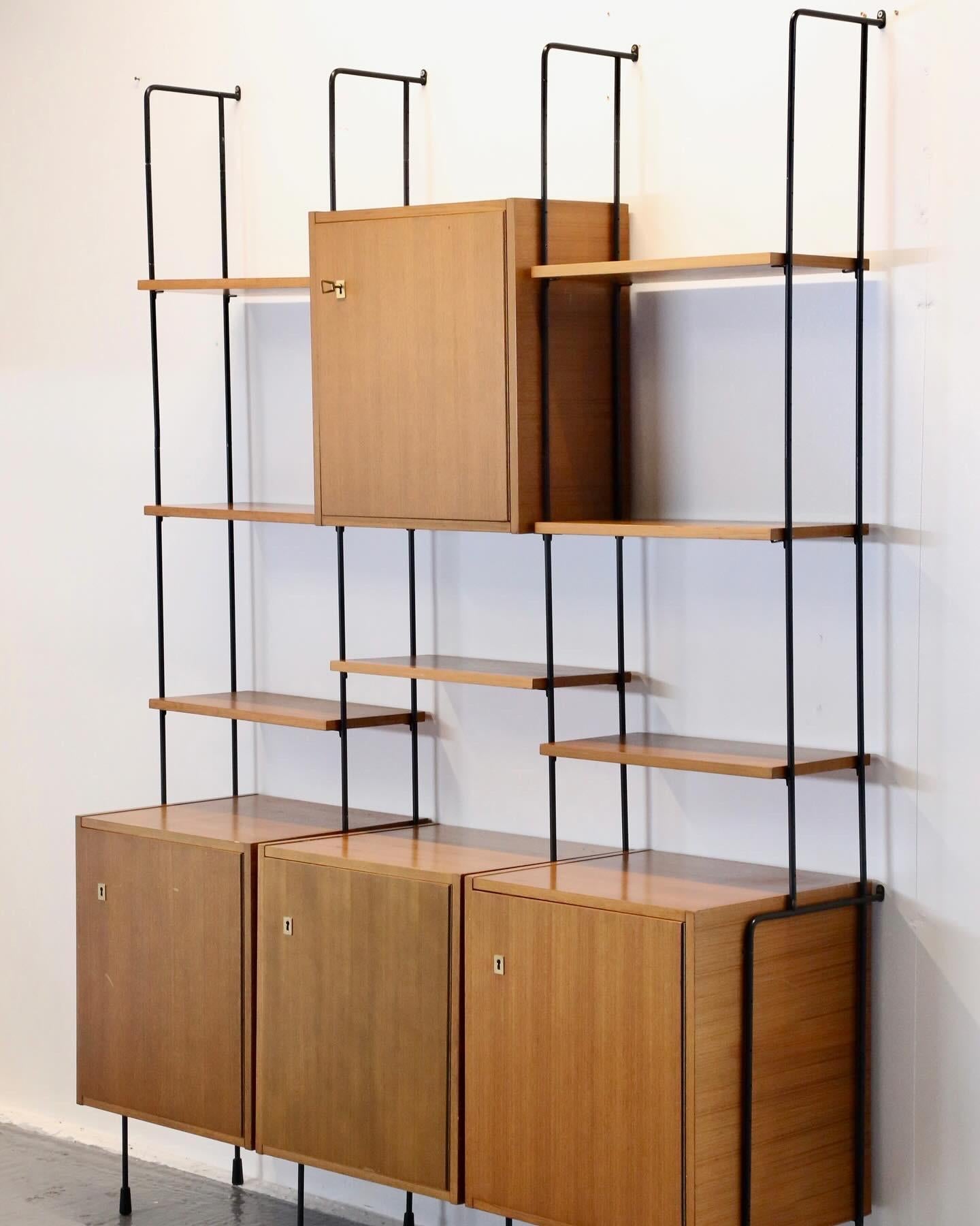 
A Fabulous German design classic ‘Omnia’ Modular Wall Unit by Ernst Dieter Hilker. Highly decorative minimalist design with black lacquered metal uprights and high quality walnut finished cabinets, and shelves - with crisp maple lined insides.