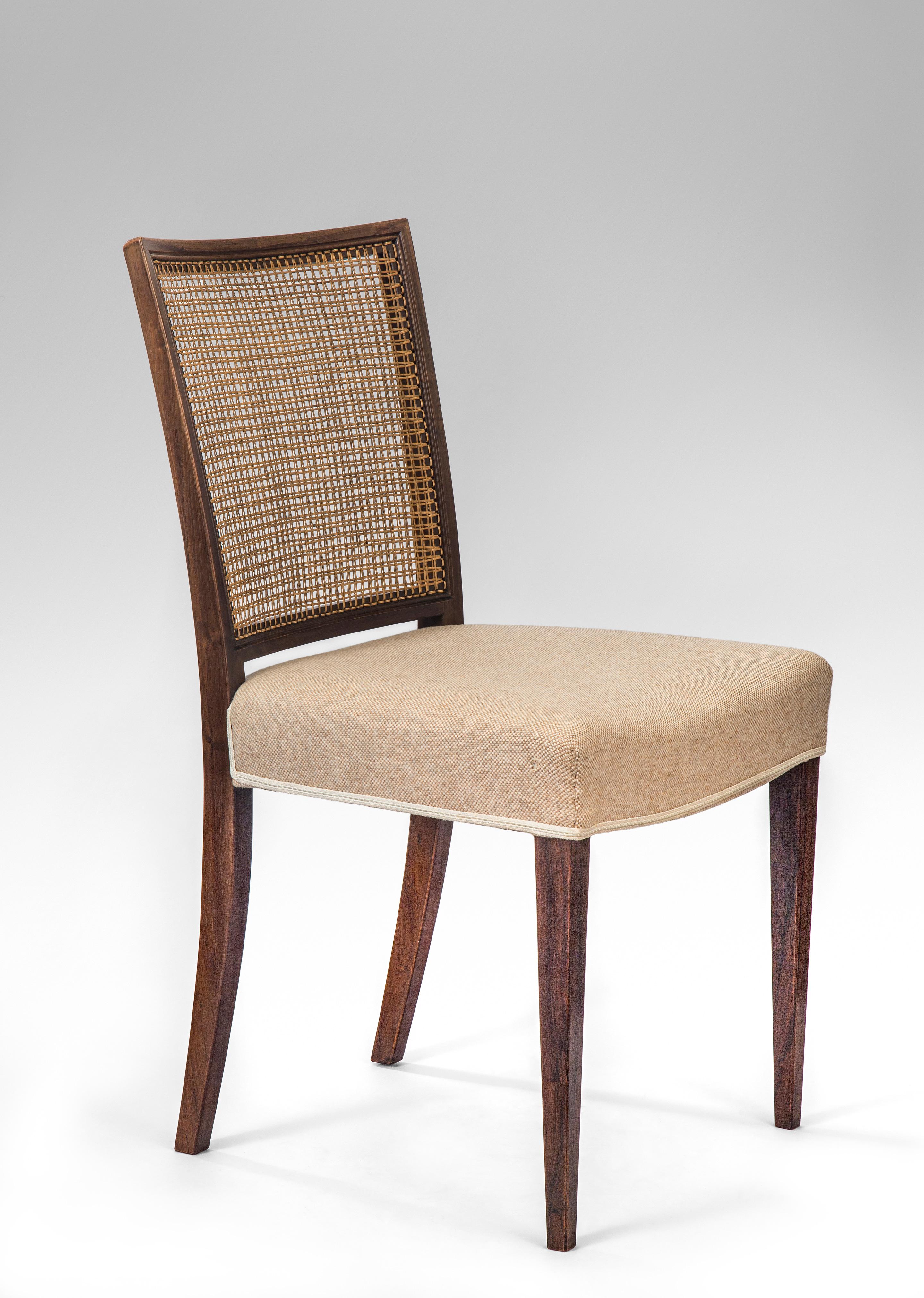 Ernst Kühn, Set of 12 Danish caned rosewood side chairs.
Mid-20th century
A very comfortable chair of richly figured rosewood. The caned rectangular back with a gentle curvature, above an upholstered seat on tapering square legs.