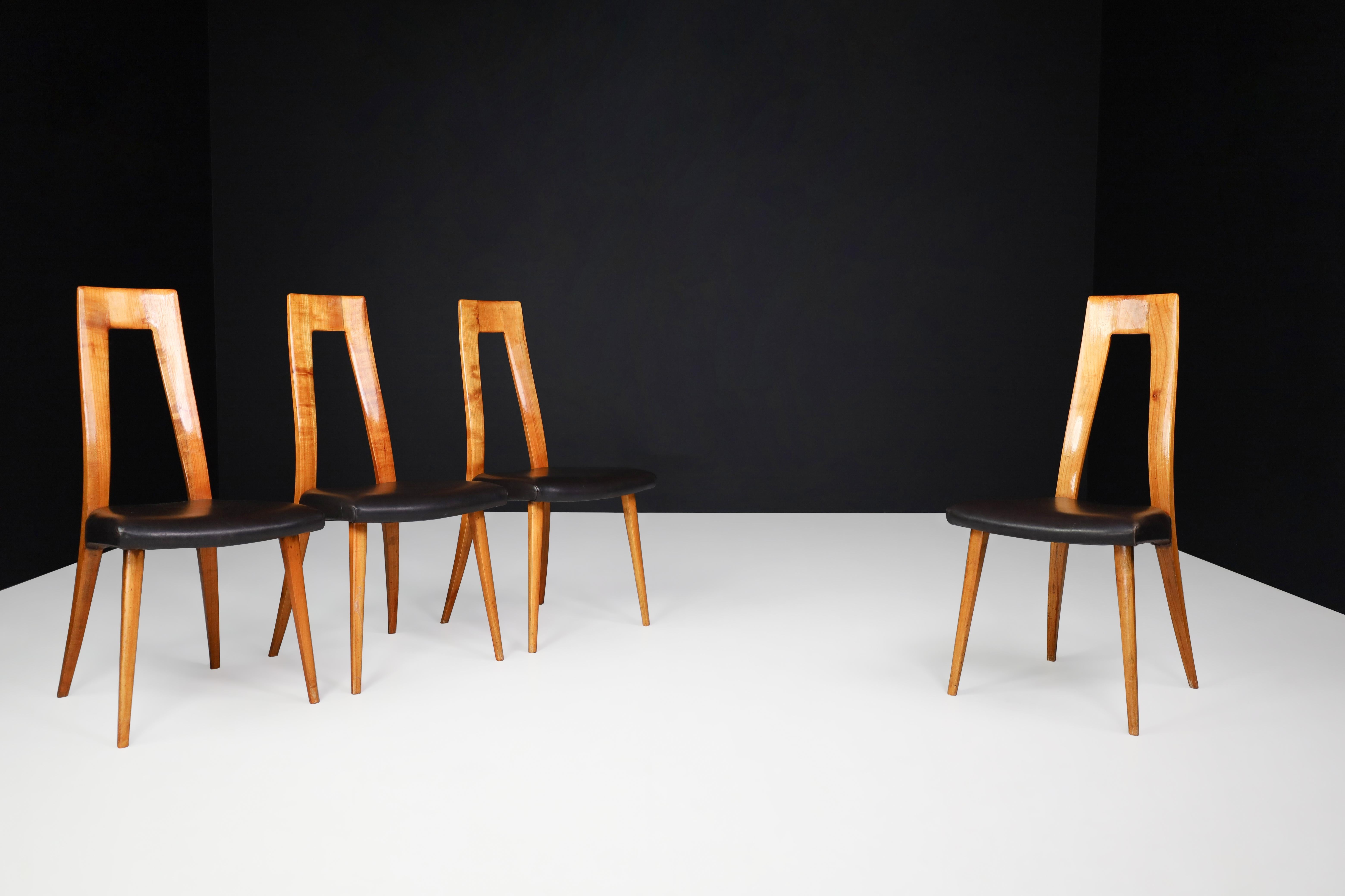 Ernst Martin Dettinger cherry wood and black Leather Dining Chairs, Germany, 1960s

A Mid-Century Modern set of four cherry wood and black leather dining chairs by Ernst Martin Dettinger was made in Germany in the 1960s. They are in excellent