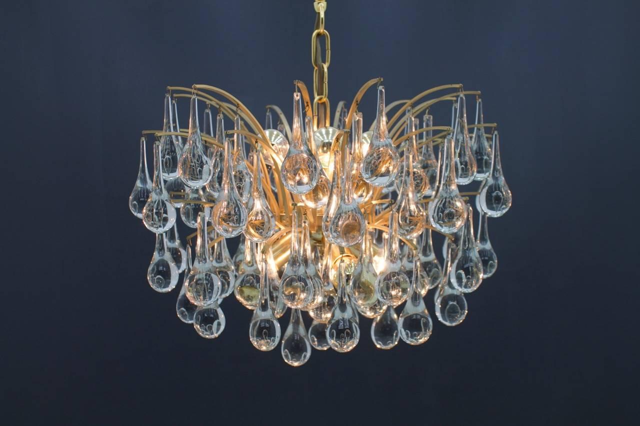 Beautiful glass drop chandelier with 97 glass drops and gilded metal frame.
8 x E 14 Socket with maximum 60 Watts per socket. 

Diameter 52 cm, height without the chain 35 cm, total height 60cm.

Very good condition.

