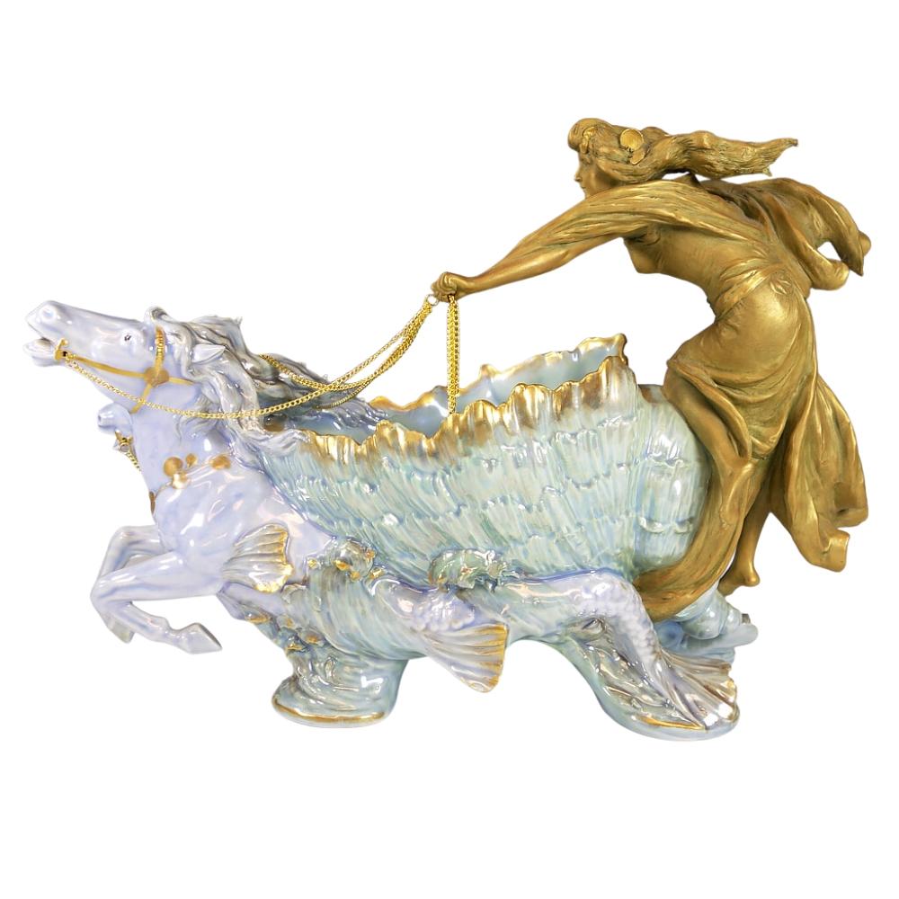 Offering this gorgeous and ultra RARE Ernst Wahliss, Art Nouveau, hand-painted, porcelain figural console vase. This tray features a golden nude maiden driving a turquoise colored shell chariot pulled by two stylized 