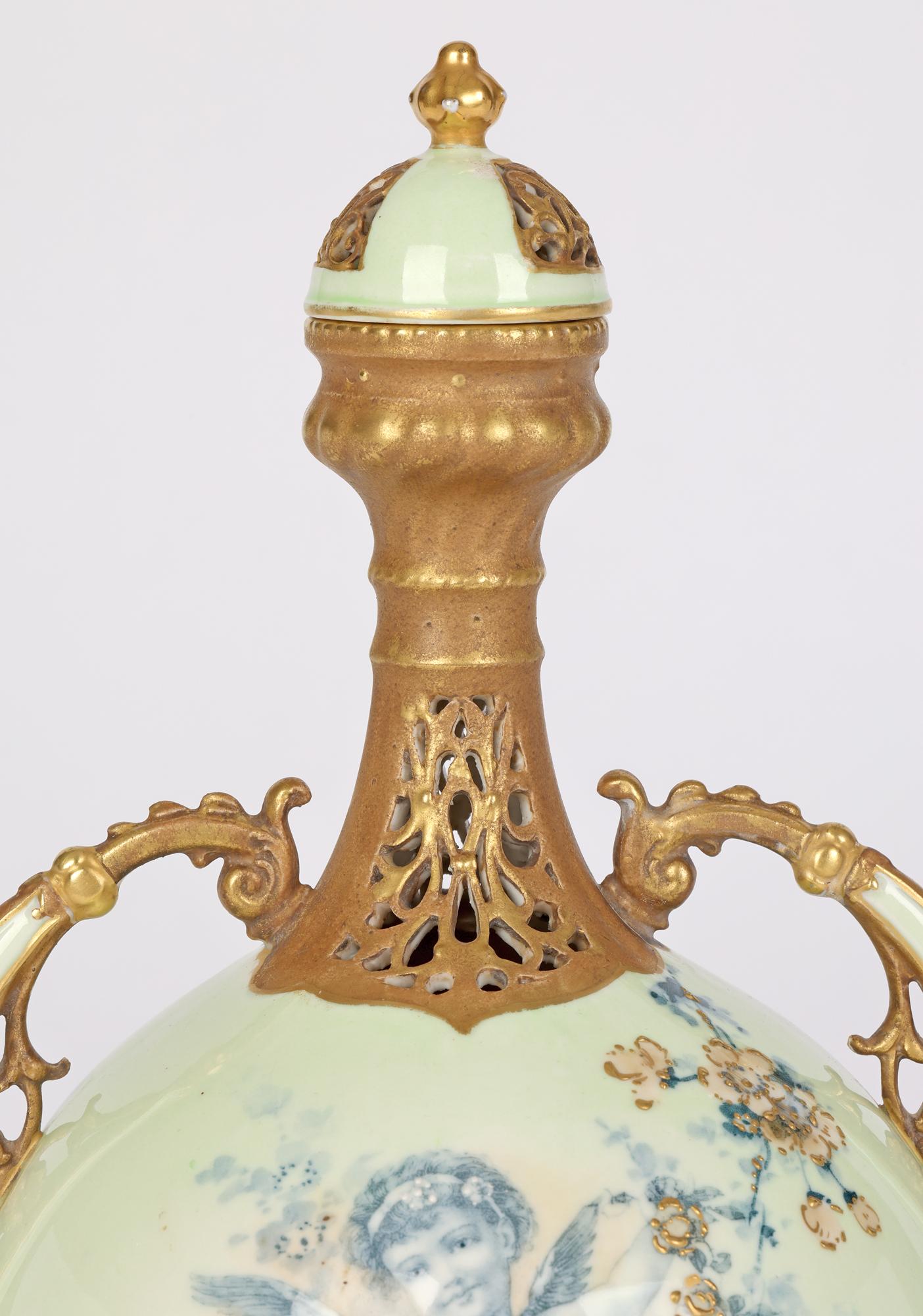 A stunning Art Nouveau Austrian twin handled porcelain lidded vase decorated with the portrait of a winged putti by renowned Austrian ceramicist Ernst Wahliss (Austrian, 1837-1900) and made around 1900. The round bodied vase stands raised on four