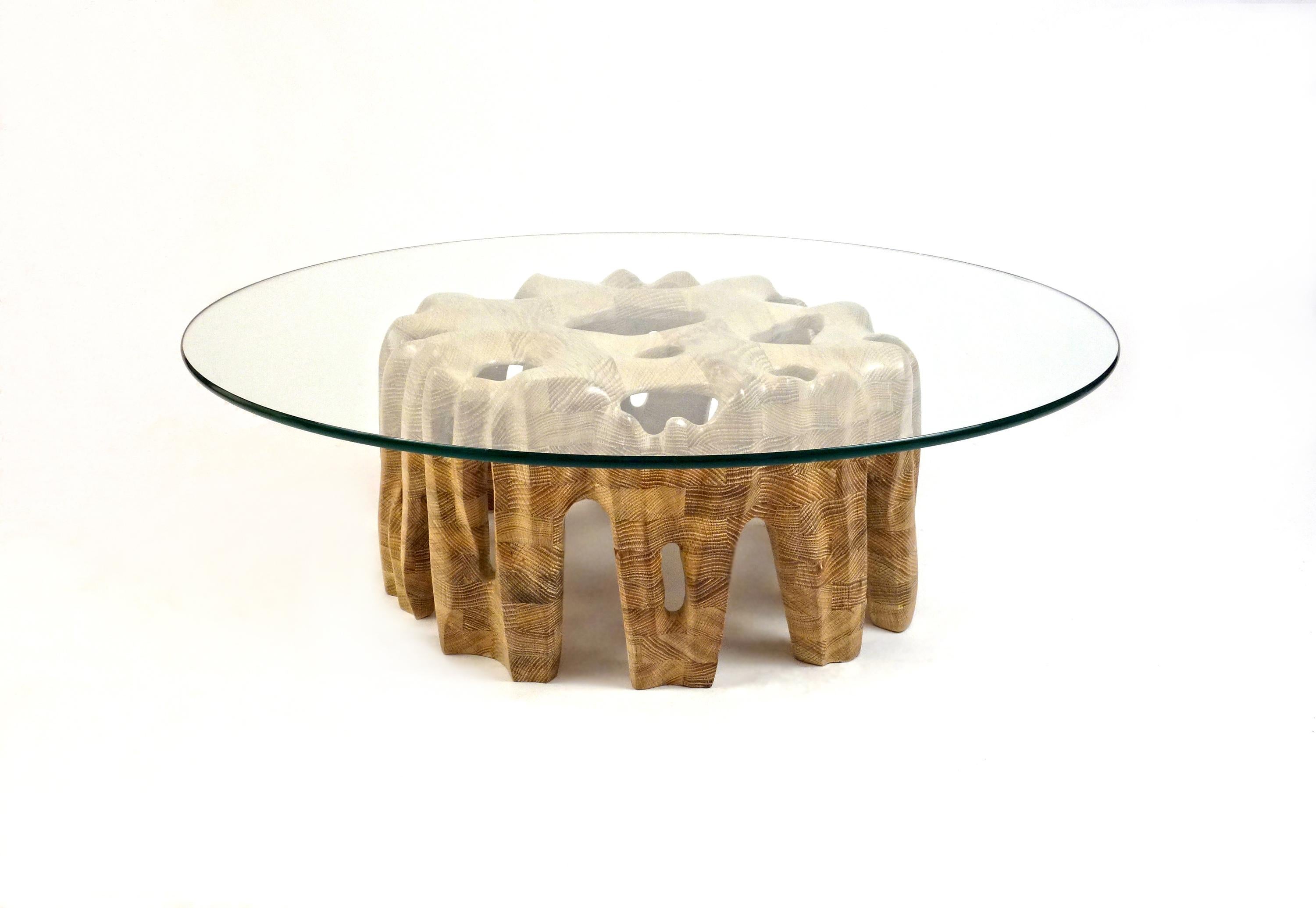 Erode Coffee Table by Aaron Scott
Dimensions: Ø 91.5 x H 30.5 cm
Materials: White oak and glass.

Hand-sculpted, solid wood coffee table with glass top, whose wood base simulates the eroded sides of a mountain. 

For all pieces in this series,