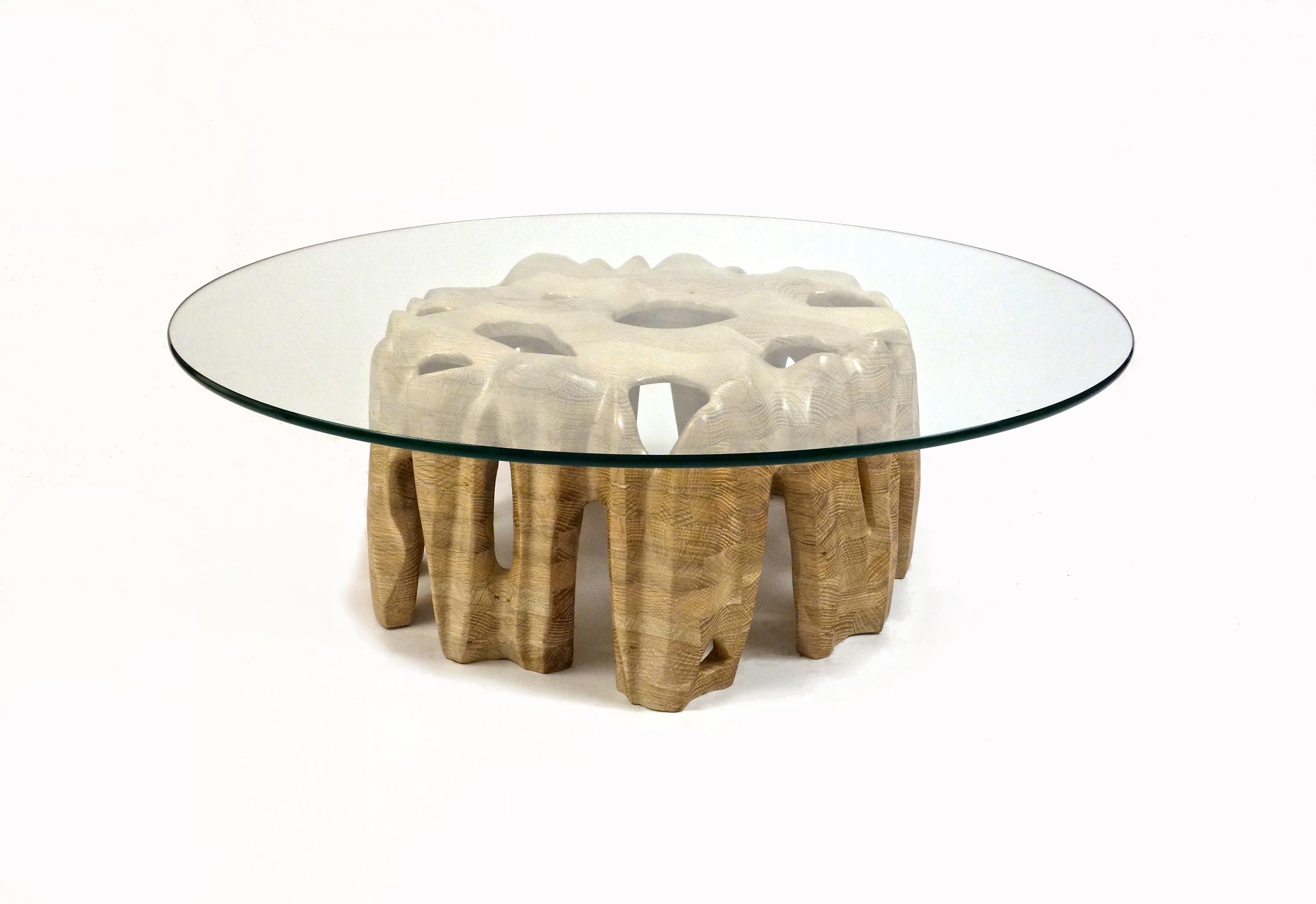 Erode Coffee Table by Aaron Scott
Dimensions: Ø 91.5 x H 30.5 cm
Materials: White oak and glass.

Hand-sculpted, solid wood coffee table with glass top, whose wood base simulates the eroded sides of a mountain. 

For all pieces in this series,