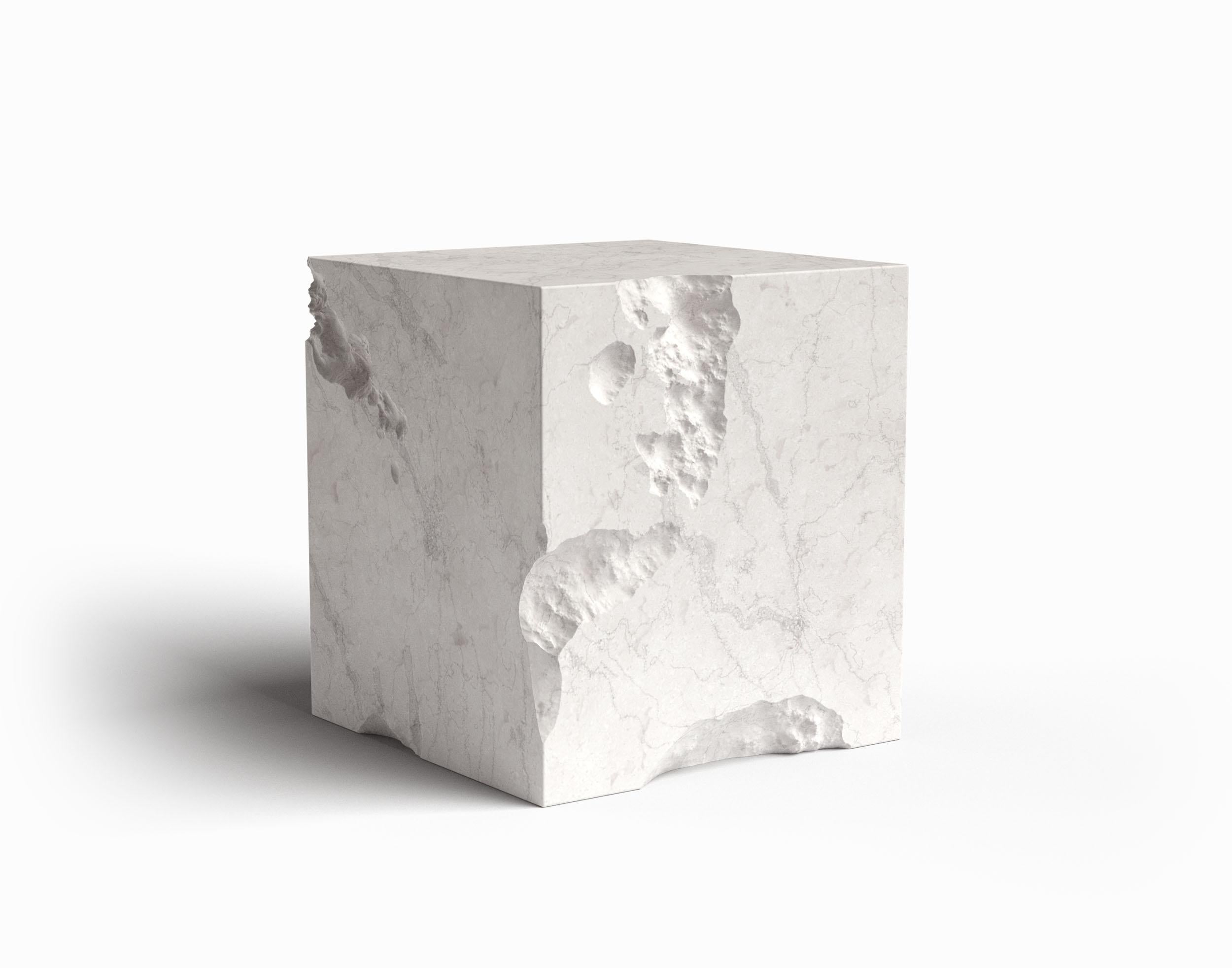 In the ephemeral dance of time, where moments surrender to the forces of nature, emerges a captivating piece of functional artistry - a cube side table in eroded marble. This sublime creation pays homage to the eternal passage of existence, as