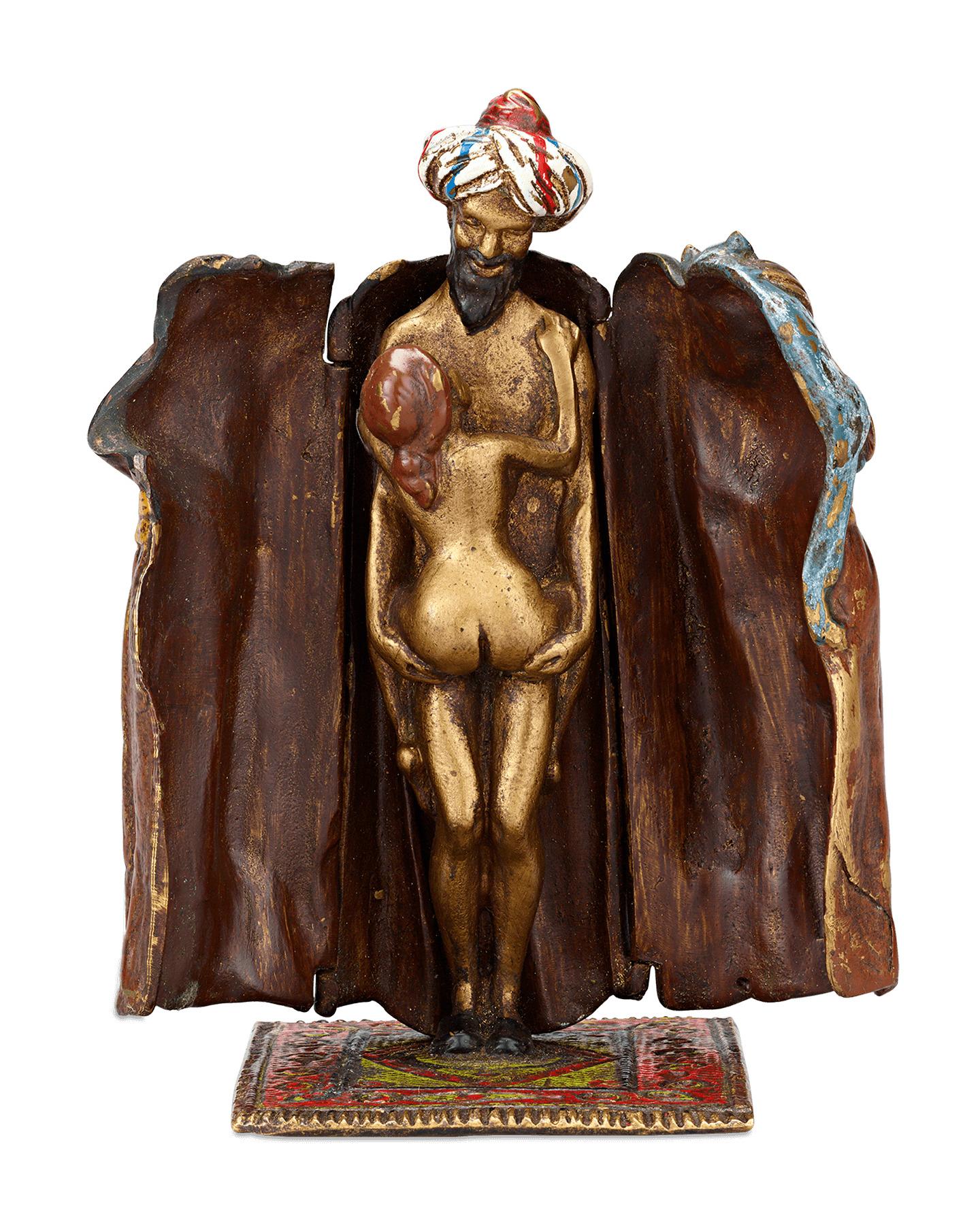 This Austrian cold-painted bronze figure attributed to Franz Bergmann hides a tantalizing secret. The figure at first appears to depict a sultan stroking a favored pet. But unlatch his robe and his arms open to reveal that this naughty man is