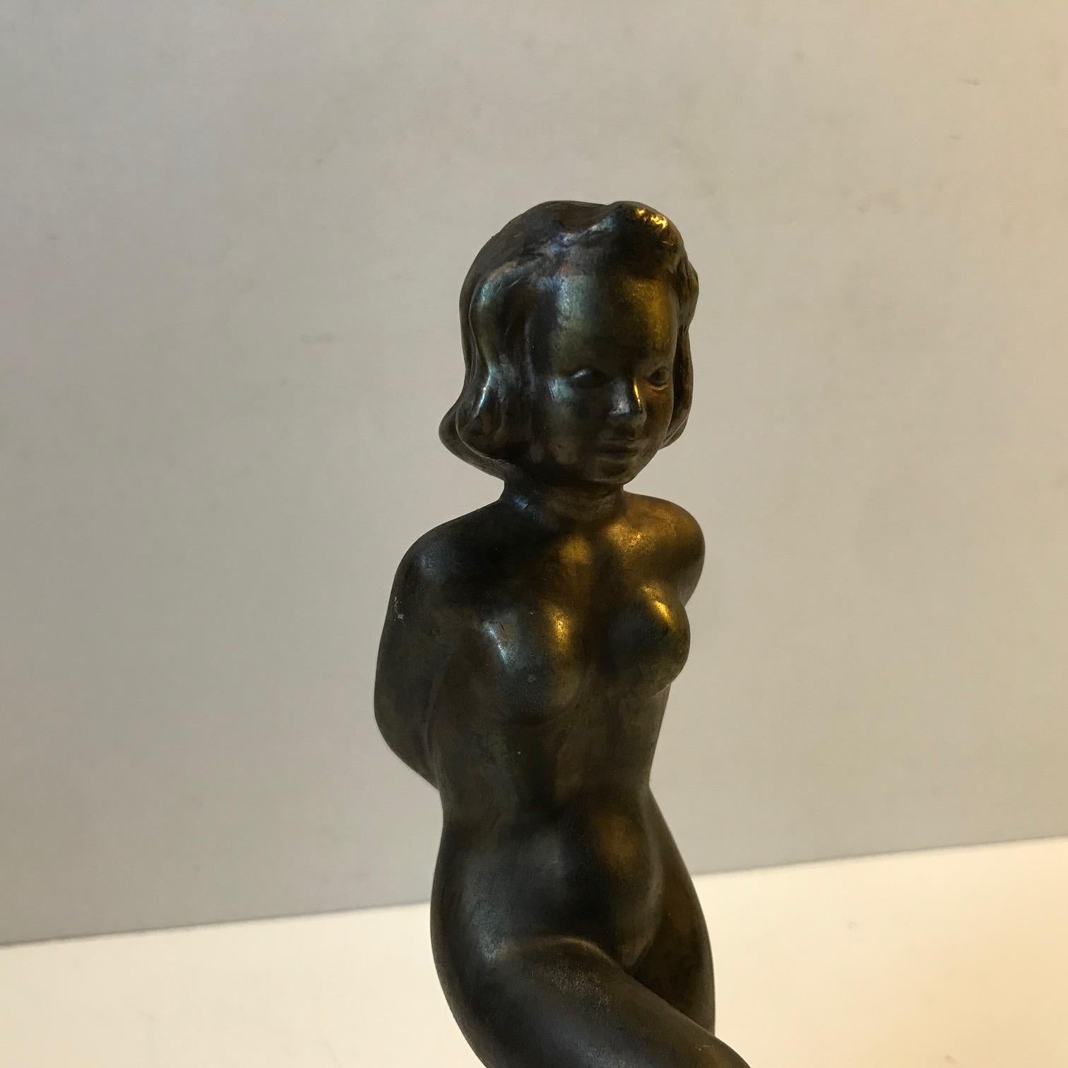 Small bronze sculpture depicting nude female. Made by the Danish artist and sculptor Ove Fritz Rasmussen, (1911-1973). It dates to the late 1940s or early 1950s. It is signed by hand to the 'stone'/base.