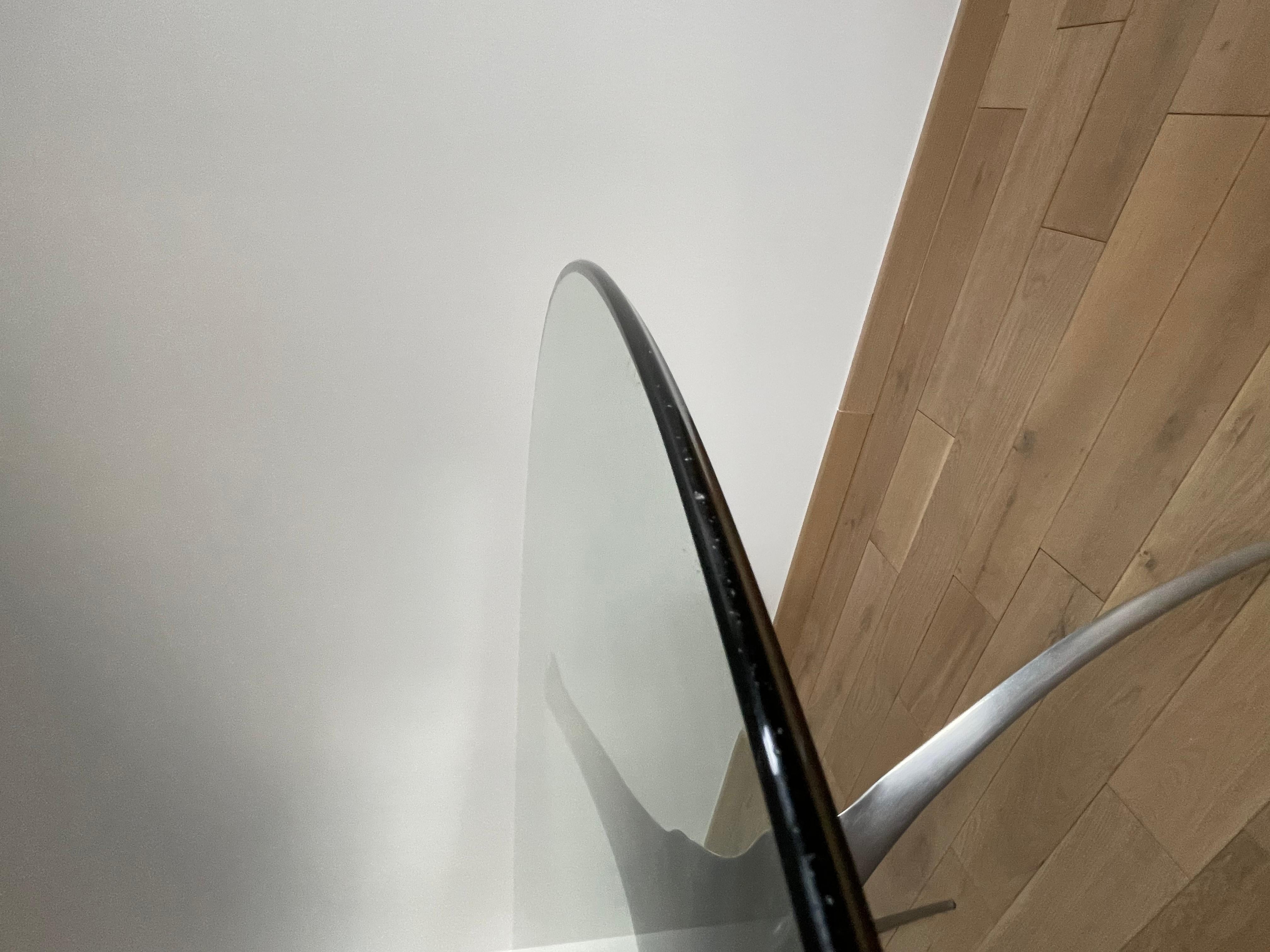 Errance model round table by Bernard Dequet for Protis and dating from the 70s. Sculptural base in polished aluminum on which rests a thick tempered glass top. The base can be arranged in both directions. Presence of slight scratches from use