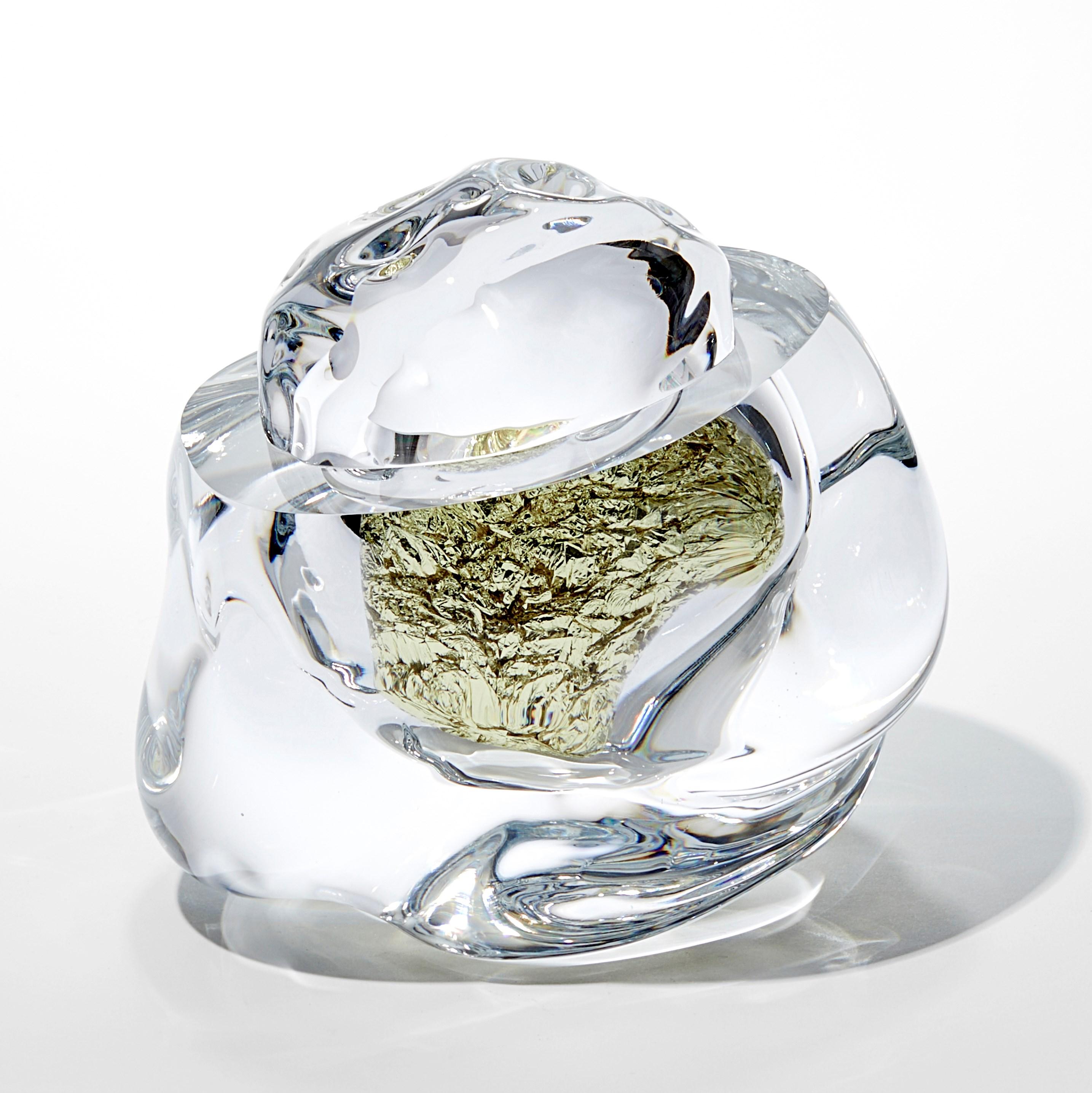 'Erratic J with 18ct Green Gold' is a handblown and cut glass sculpture created by the British artist, Anthony Scala.

The geological term 'erratic' refers to a stone or boulder that differs to its surrounding rock, that is believed to have been