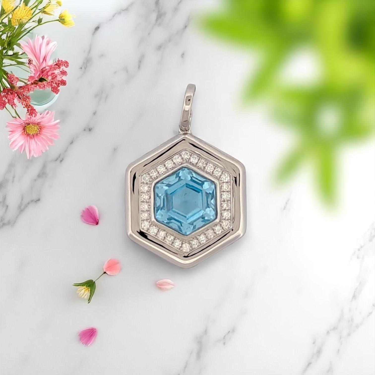 Sleek. Sculptural. Striking. The Ersilia Pendant by Mountain Song Jeweler is a bold expression of modern elegance. Set in luminous 18k white gold, this statement pendant features a mesmerizing 3.30 carat hexagon-cut Blue Topaz, glowing with icy