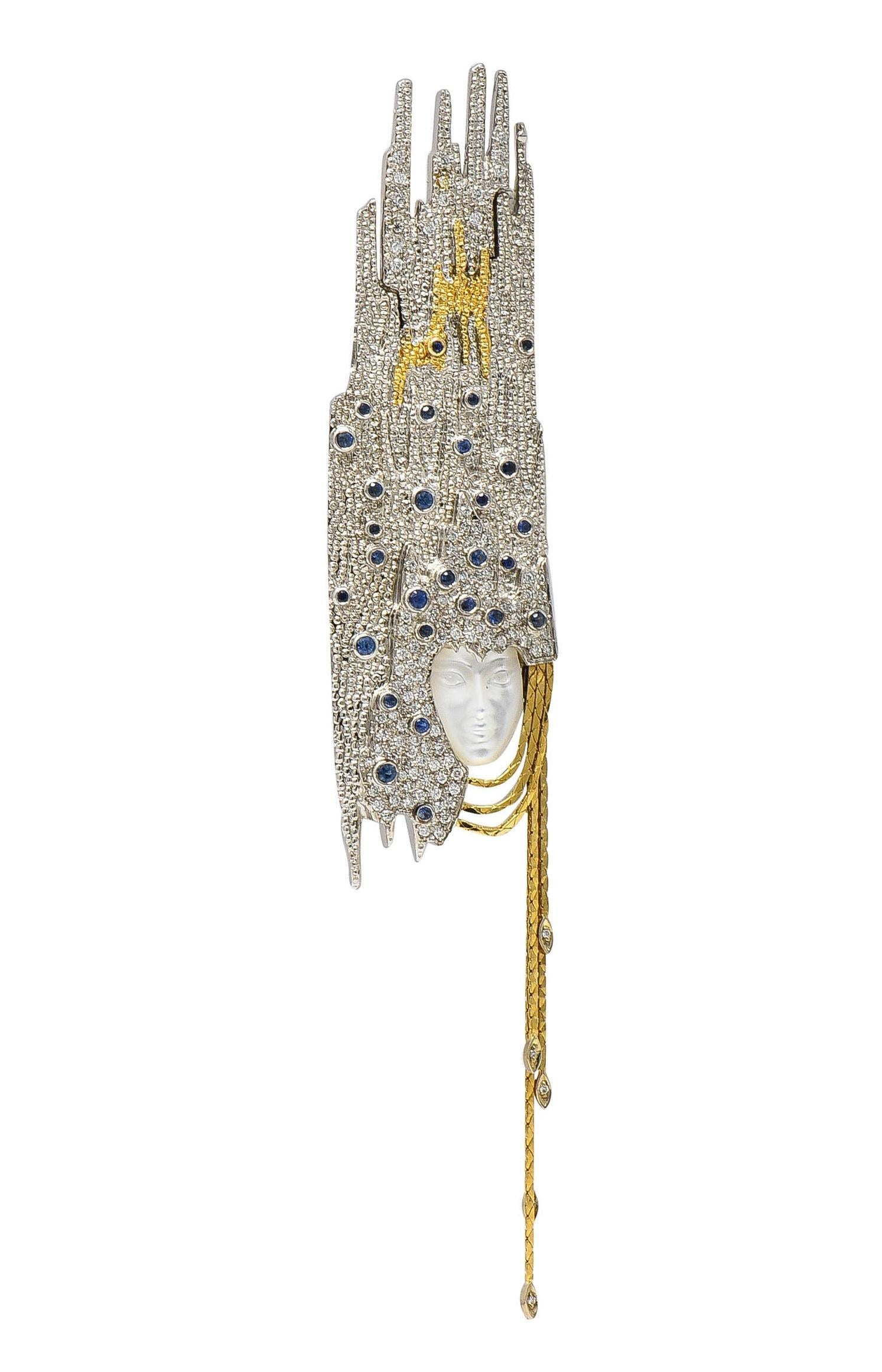 Comprised of hinged panels with a stipple texture throughout and organically jagged edges
Sterling silver with segments of yellow gold and centering an elongated station
Depicting a woman wearing a headdress with gold articulating chain tassels