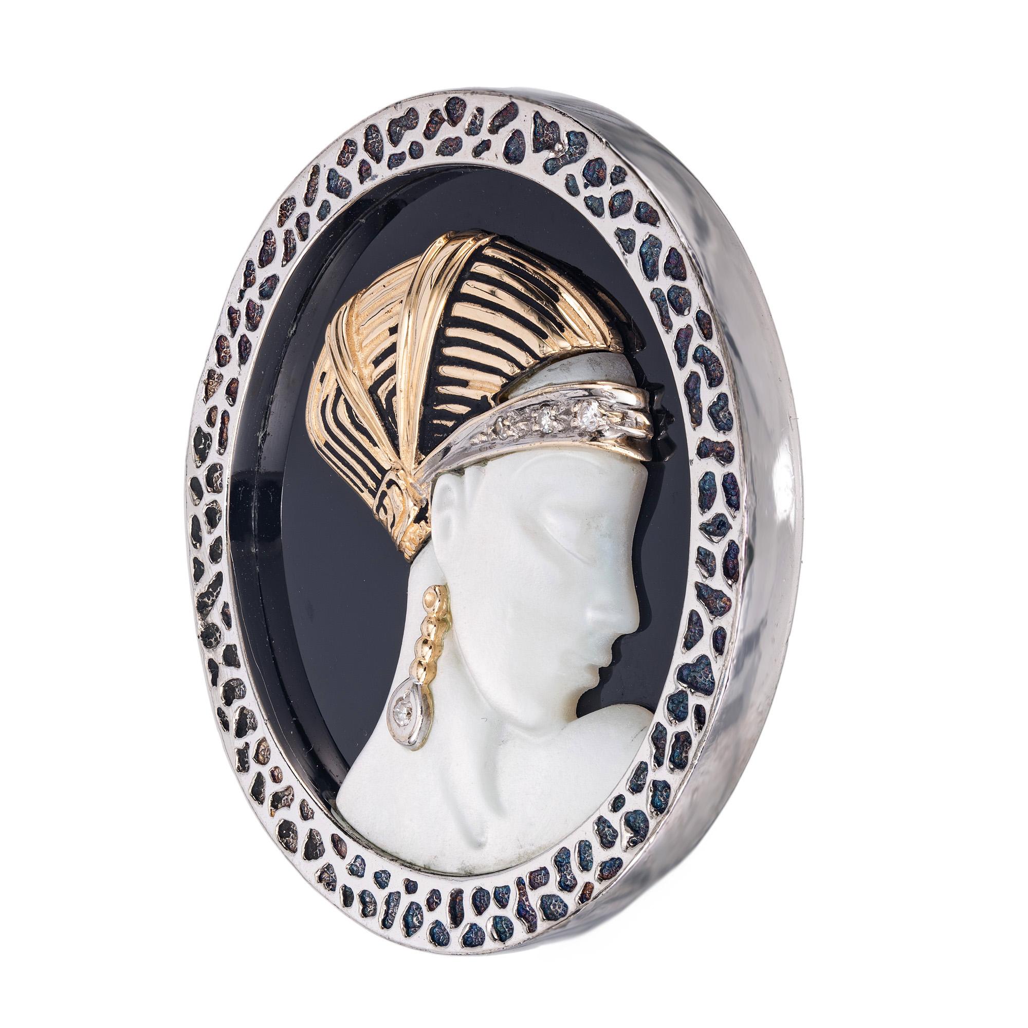 From designer Erté comes this Loves Enchantment, Ca 1980 sterling silver and yellow gold, onyx, Mother of pearl and diamond brooch. Elegance blooms in every detail. 4 round brilliant cut diamonds. The brooch is crafted in silver, 18k yellow gold