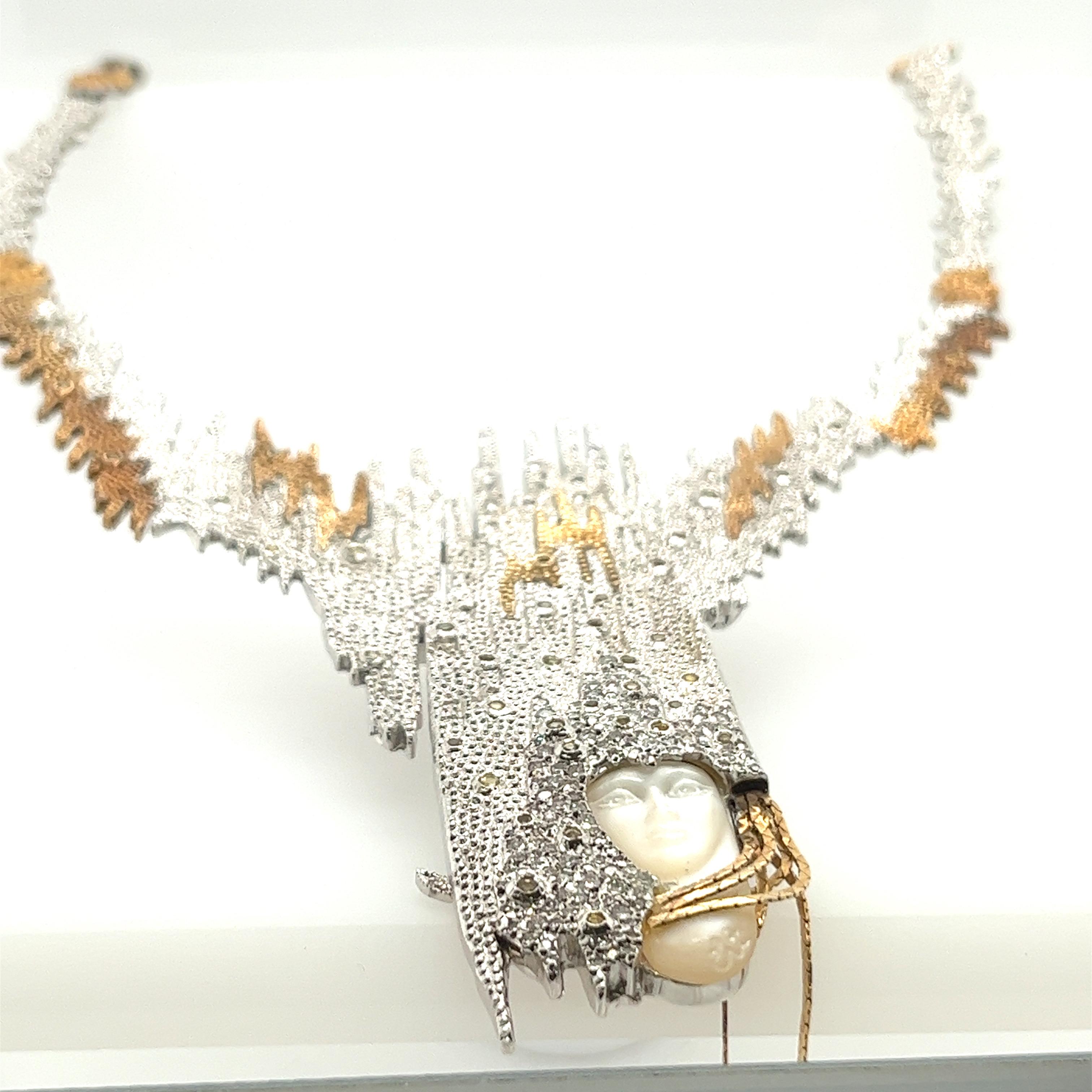 Made famous by Loni Anderson comes this limited edition Erte necklace. The centerpiece is a woman's face surrounded by a 14k gold headress that is encrusted with round brilliant cut diamonds. This piece also has 43 bezel set round cabuchon cut