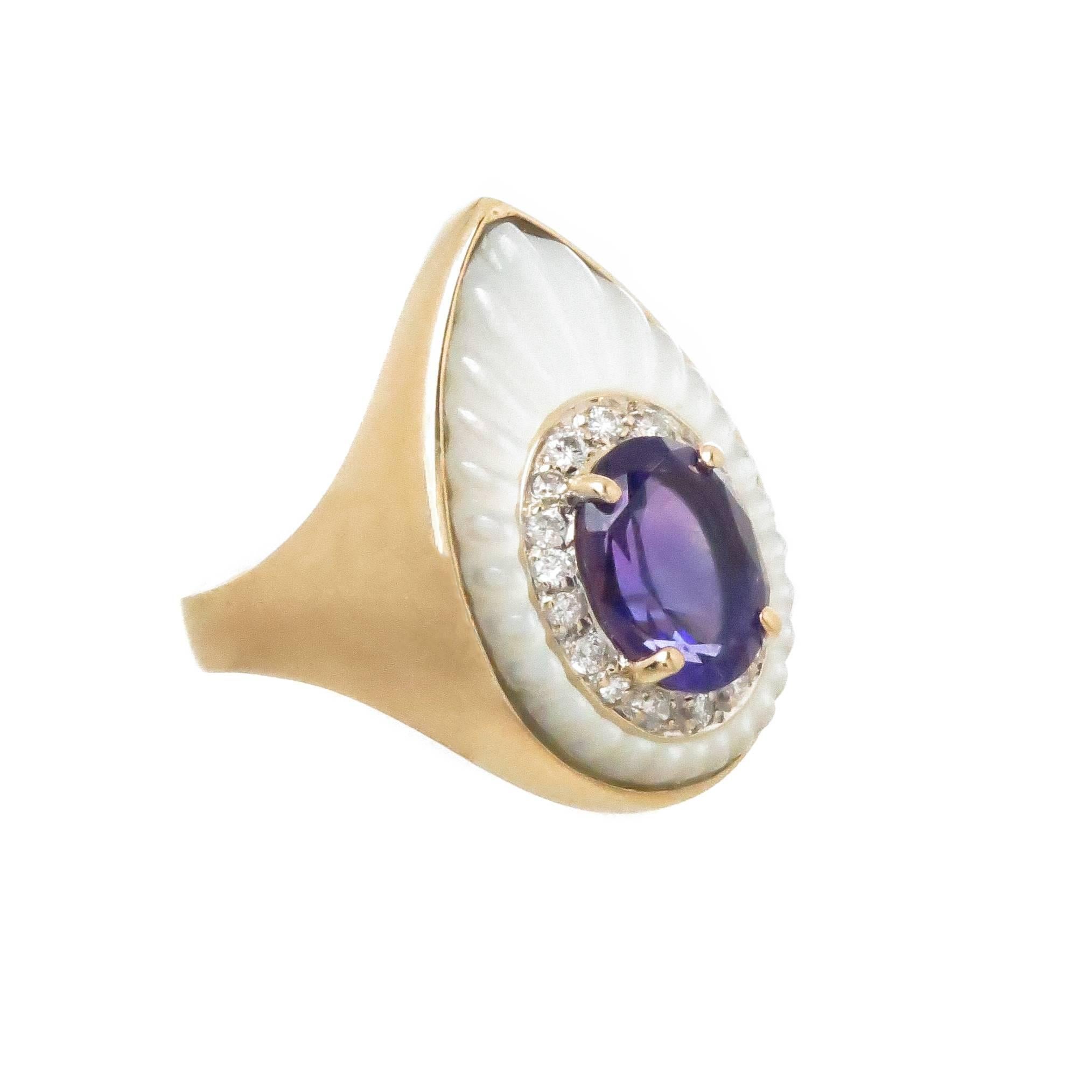 Circa 1980 Erte Clair De Lune Ring, 14K Yellow Gold, Mother of Pearl and centrally set with an oval Amethyst surrounded by Diamonds. Ring top measurements 7/8 inch in length X 1/2 inch. Finger size = 7
