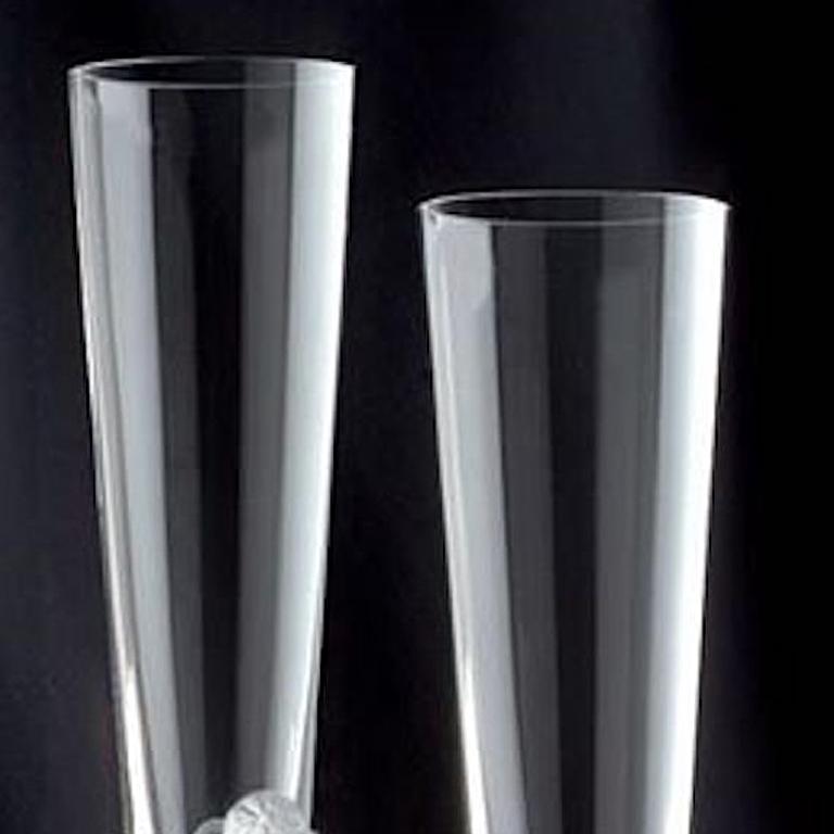 A pair of glamorous champagne flutes, titled “Flute Majestique,” after the designs of the well-known Art Deco artist Erté (Romain de Tirtoff), the grandfather of Art Deco, each bearing his etched signature.  The flutes are hand finished with a