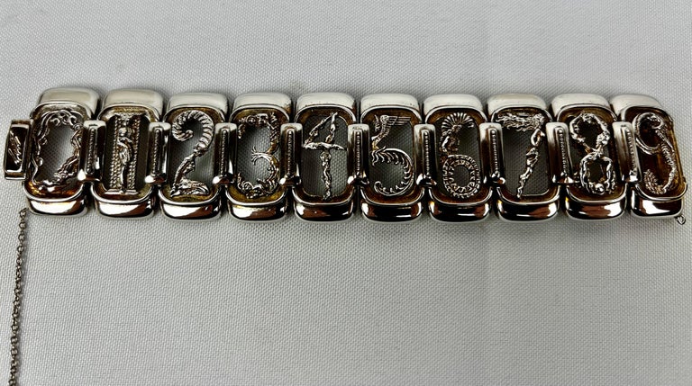 Erté  (1892-1990) sterling silver and vermeil figural numbers bracelet made for Circle Fine Art Galleries.
Links 0 through 9 each representing a female form.  The bracelet has a box clasp and a safety chain with lobster closure for safety.  7 1/8