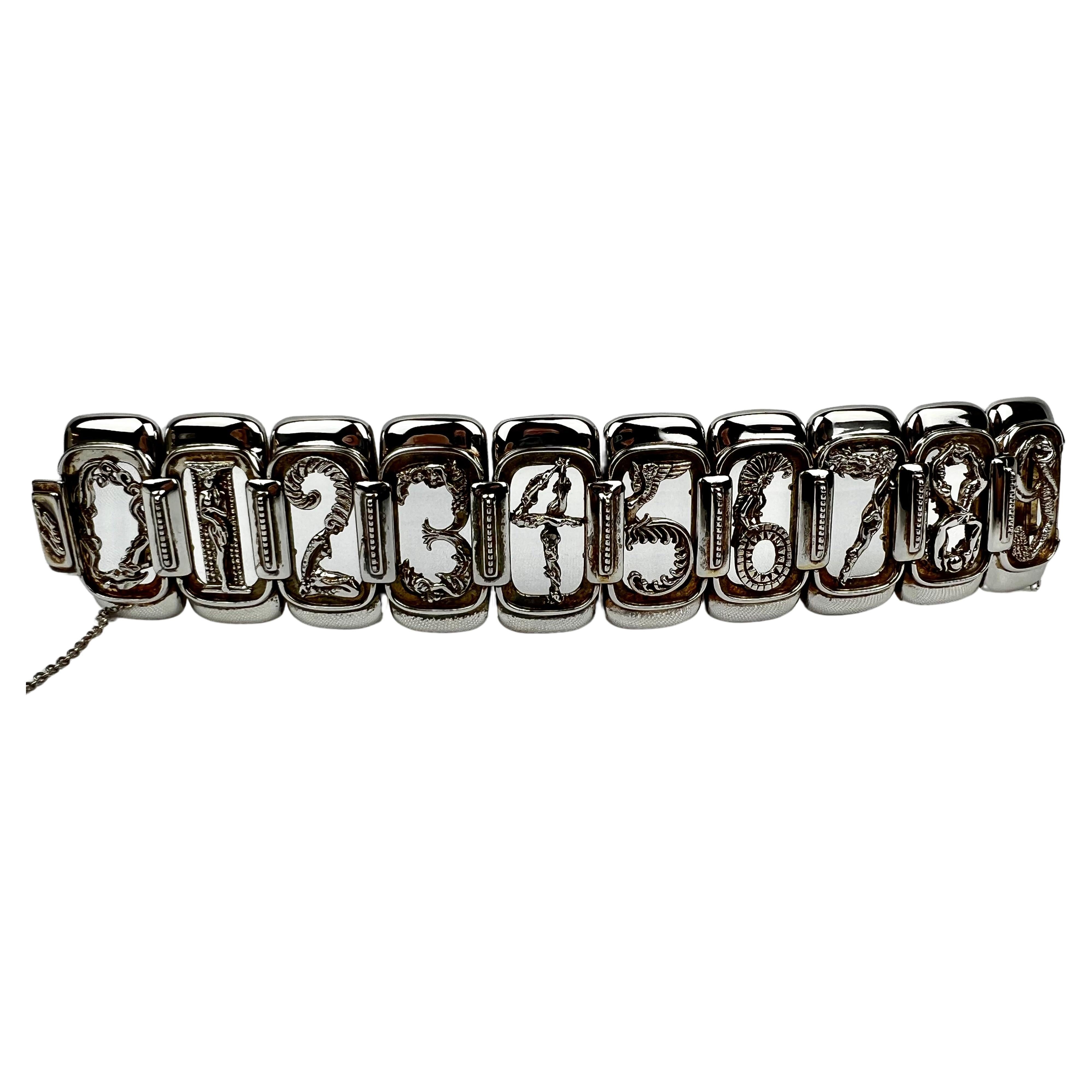 Erté  (1892-1990) sterling silver and vermeil figural numbers bracelet made for Circle Fine Art Galleries.
Links 0 through 9 each representing a female form.  The bracelet has a box clasp and a safety chain with lobster closure for safety.  7 1/8
