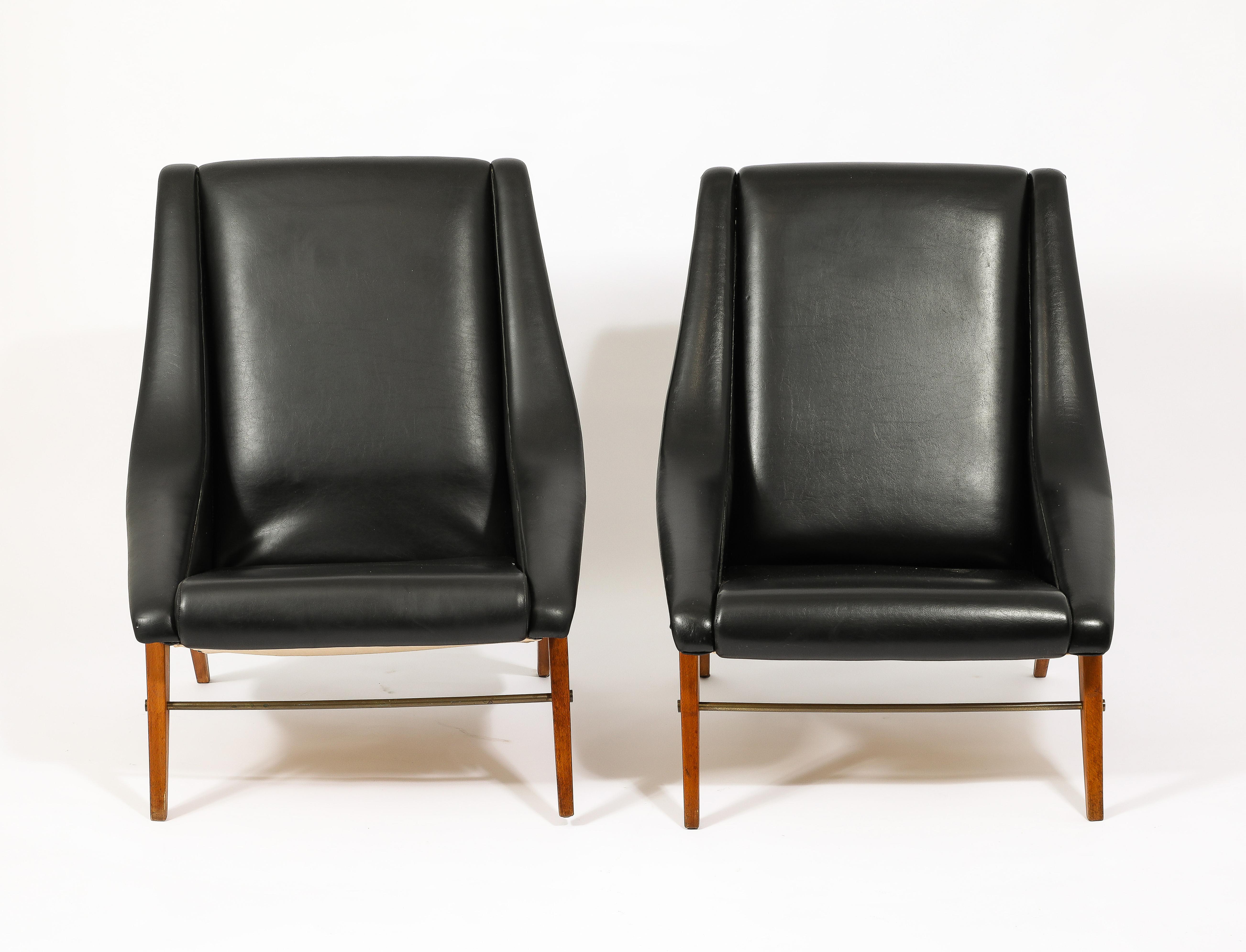 Very Elegantly designed armchairs on compass beech legs with a brass stretcher.
A never-before-seen before model by this brand. Signed with metal tag label to underside.