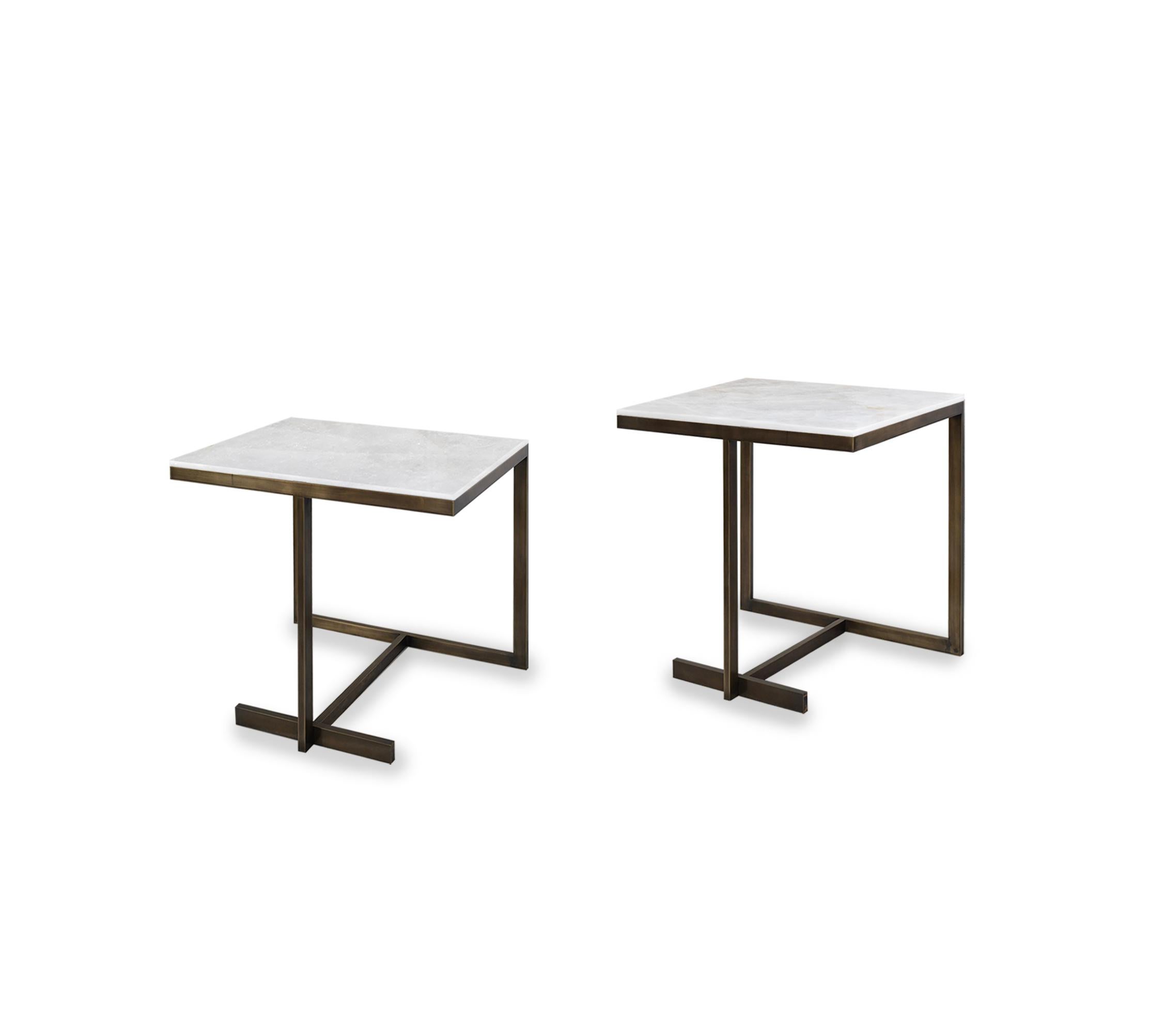 Pair of elegant form side tables with rock crystal tops. Antique brass finish. Created by Phoenix Gallery, NYC. 
Custom size and finish upon request.