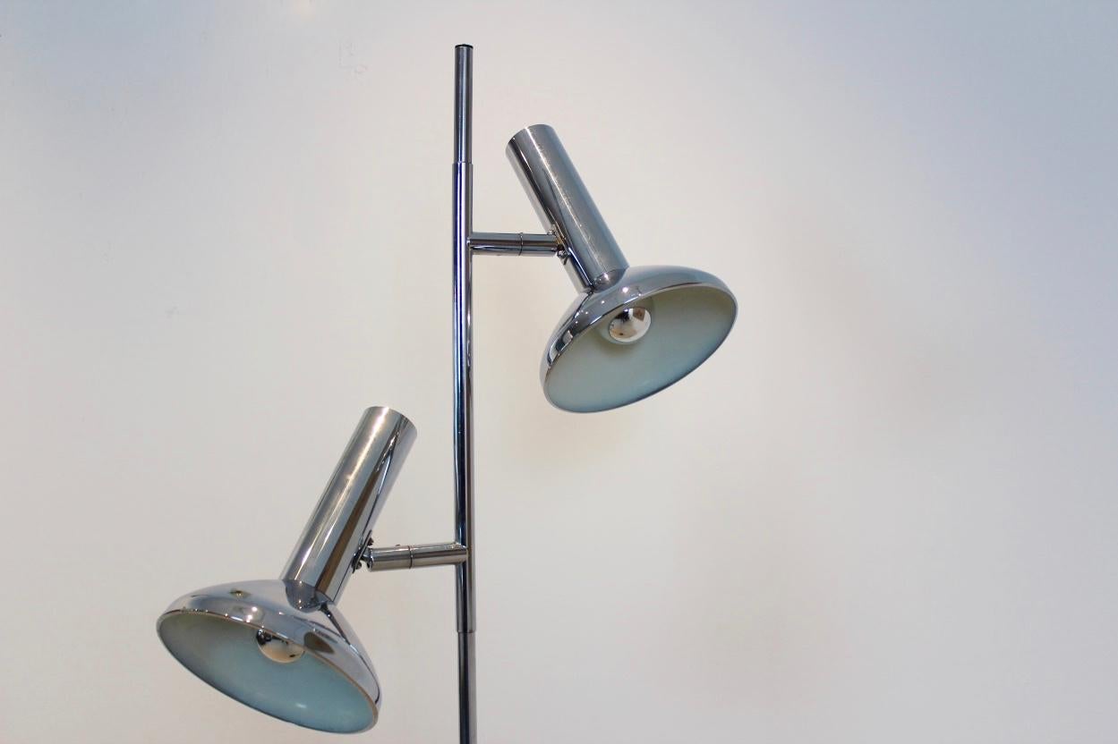 Clean design chrome-plated metal floor lamp by Erwi lighting, the Netherlands. This was a side brand of Philips lighting. A 1960s chrome floor lamp with two lights, each of which is hinged, pivoting for a full range of motion. In perfect