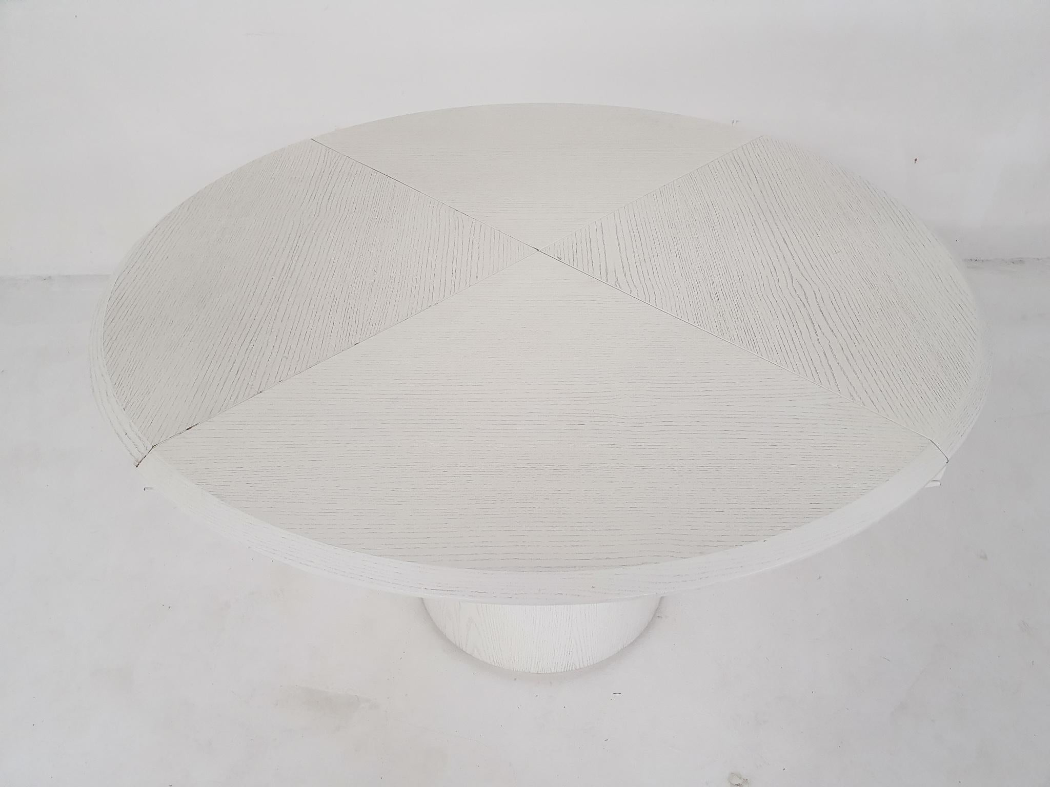White ash-wooden dining table which has four leaves to turn the table from a round into a square table.
The height of the table is 70 cm and will be 76 cm when it is round (diameter 125cm).