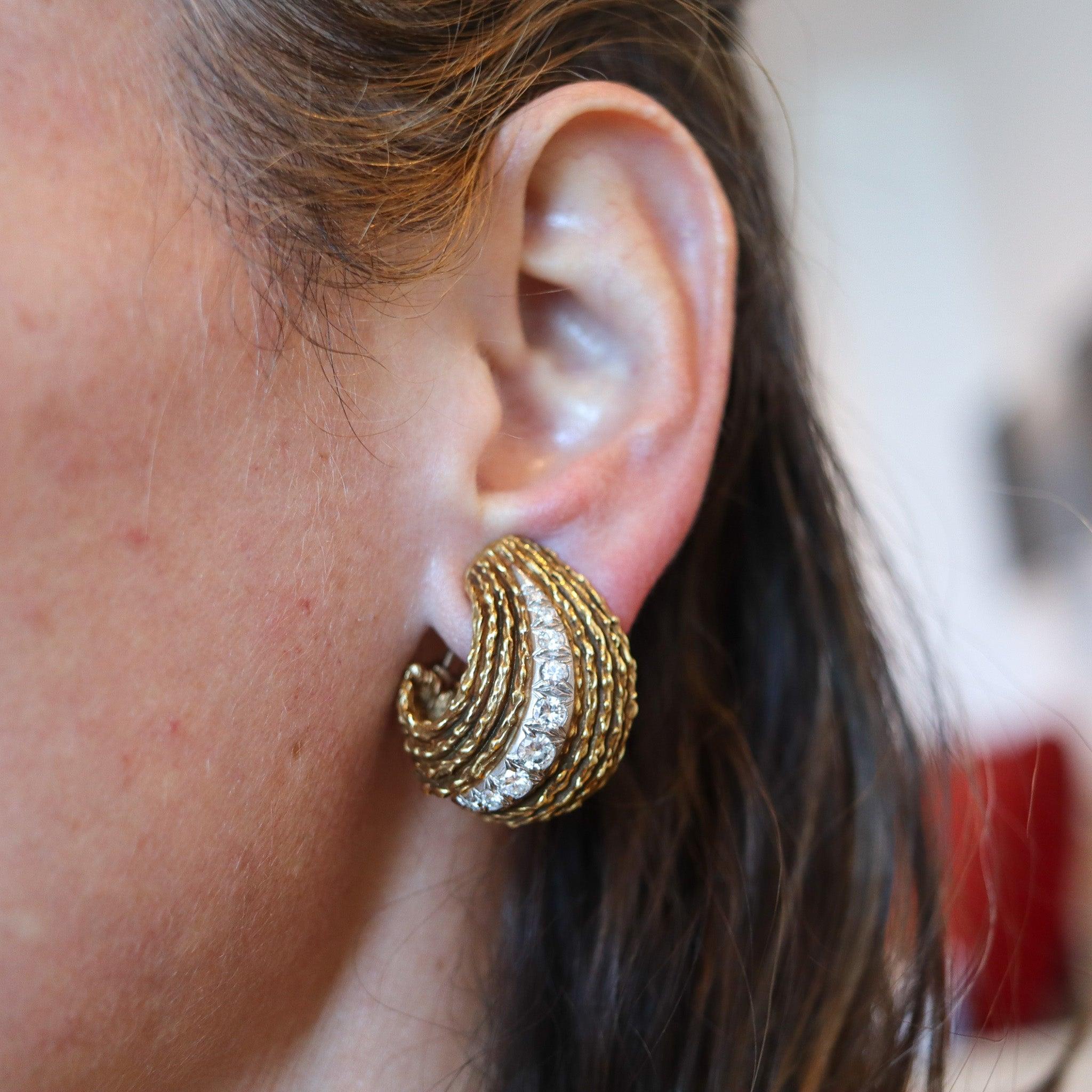 Pair of clips-on earrings designed by Erwin Pearl.

This is a pair of exuberant clips-on earrings, created by the American jewelry designer Erwin Pearl, back in the 1970. This pair is a real statement and has been crafted with curved patterns in